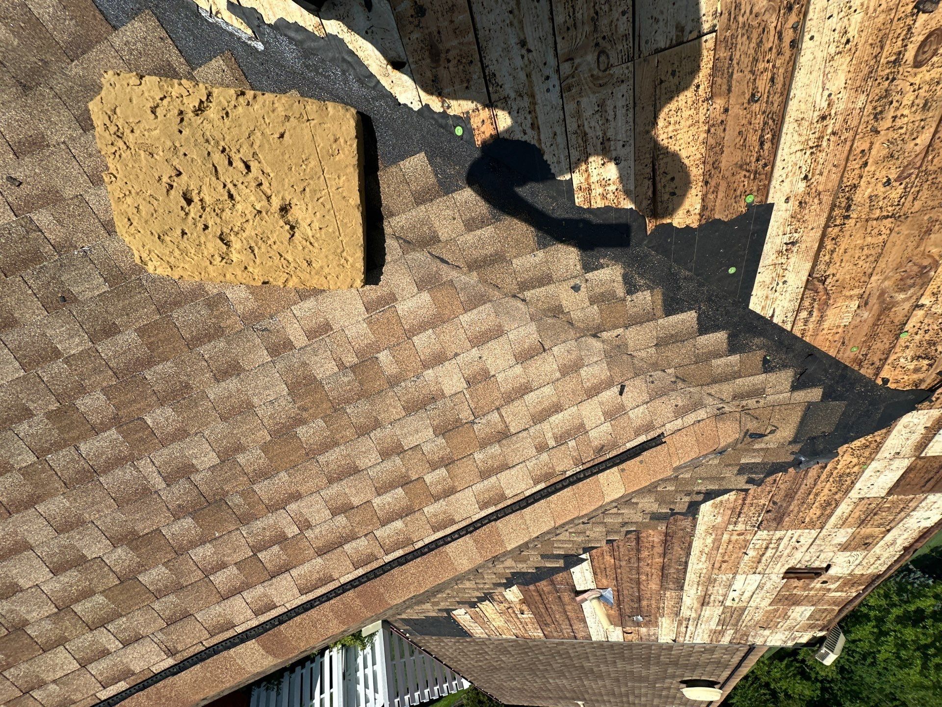 Original shingles beside bare plank decking