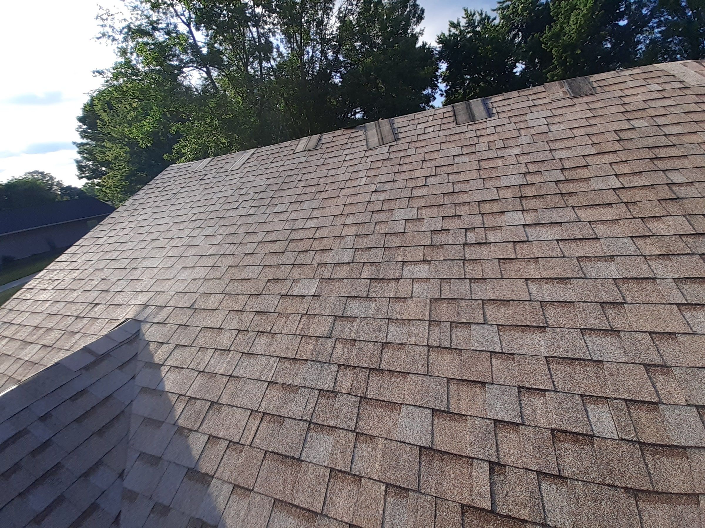Shingled slope climbing to a ridge lined with cap pieces, Jamestown, Ohio.