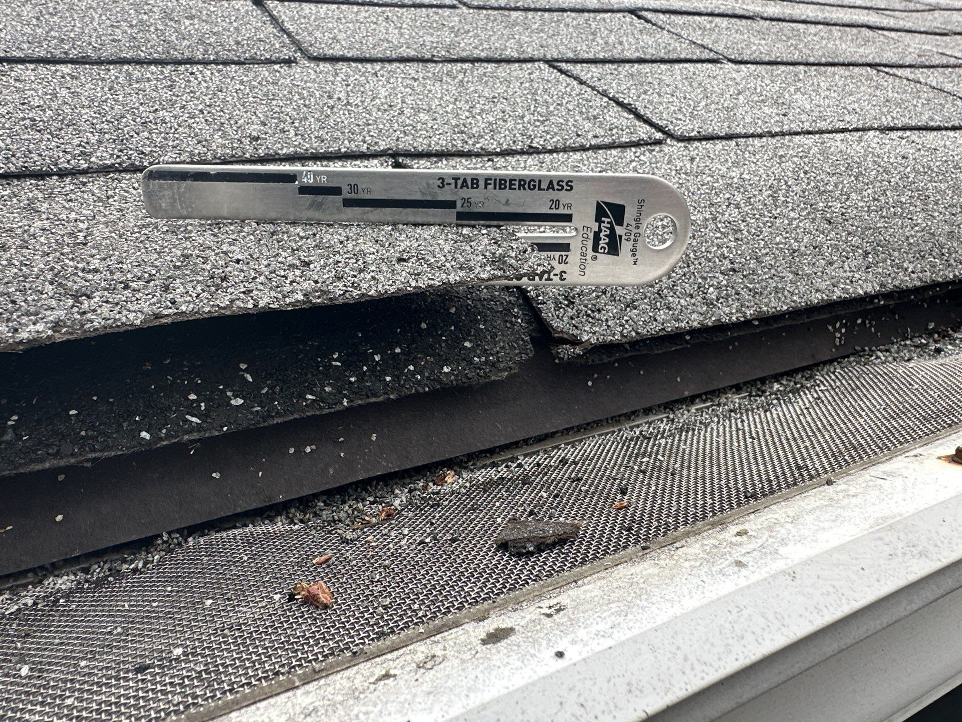 A shingle gauge measuring three-tab shingle thickness, Kettering, Ohio.