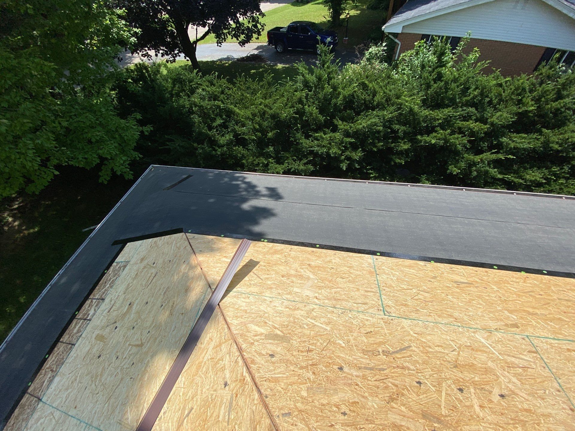 Dark membrane rolled along the eaves over the new sheathing, Beavercreek, Ohio.