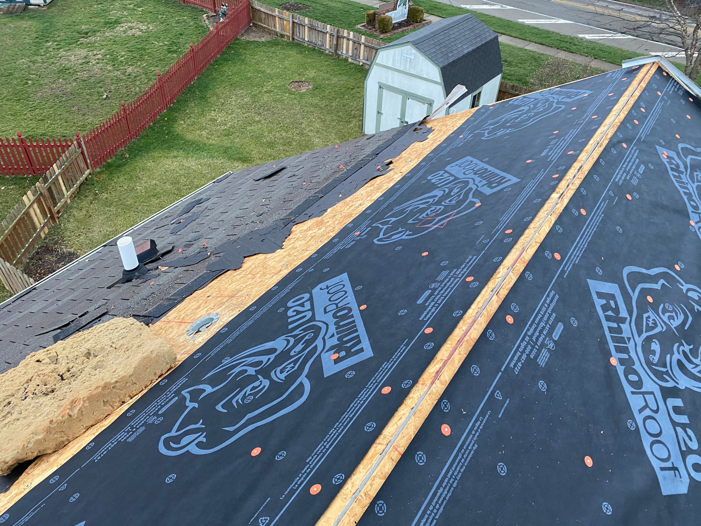 Old shingles, bare decking and underlayment