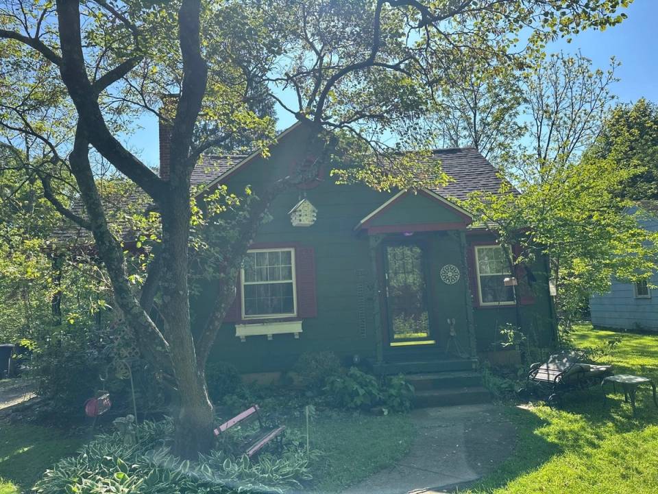 The green cottage and its front garden under the trees, Springfield, Ohio.