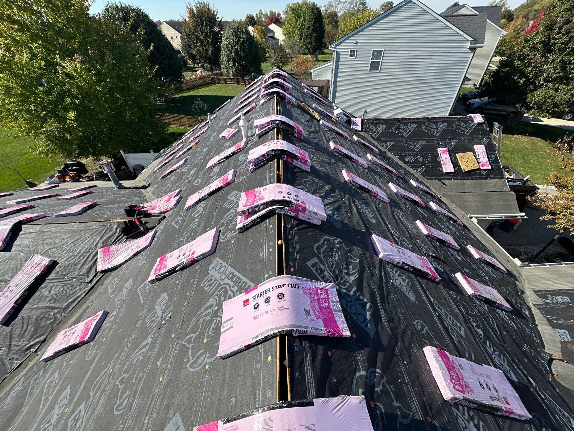 Bundles draped over the ridge of a gable beside the neighboring house, Beavercreek, Ohio.