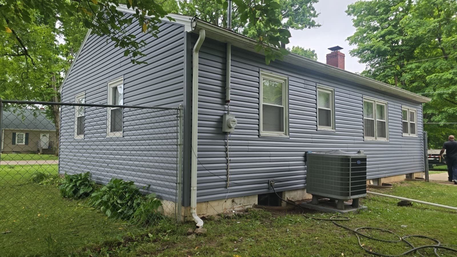 New siding along the fence line on the side of the house, Beavercreek, Ohio.