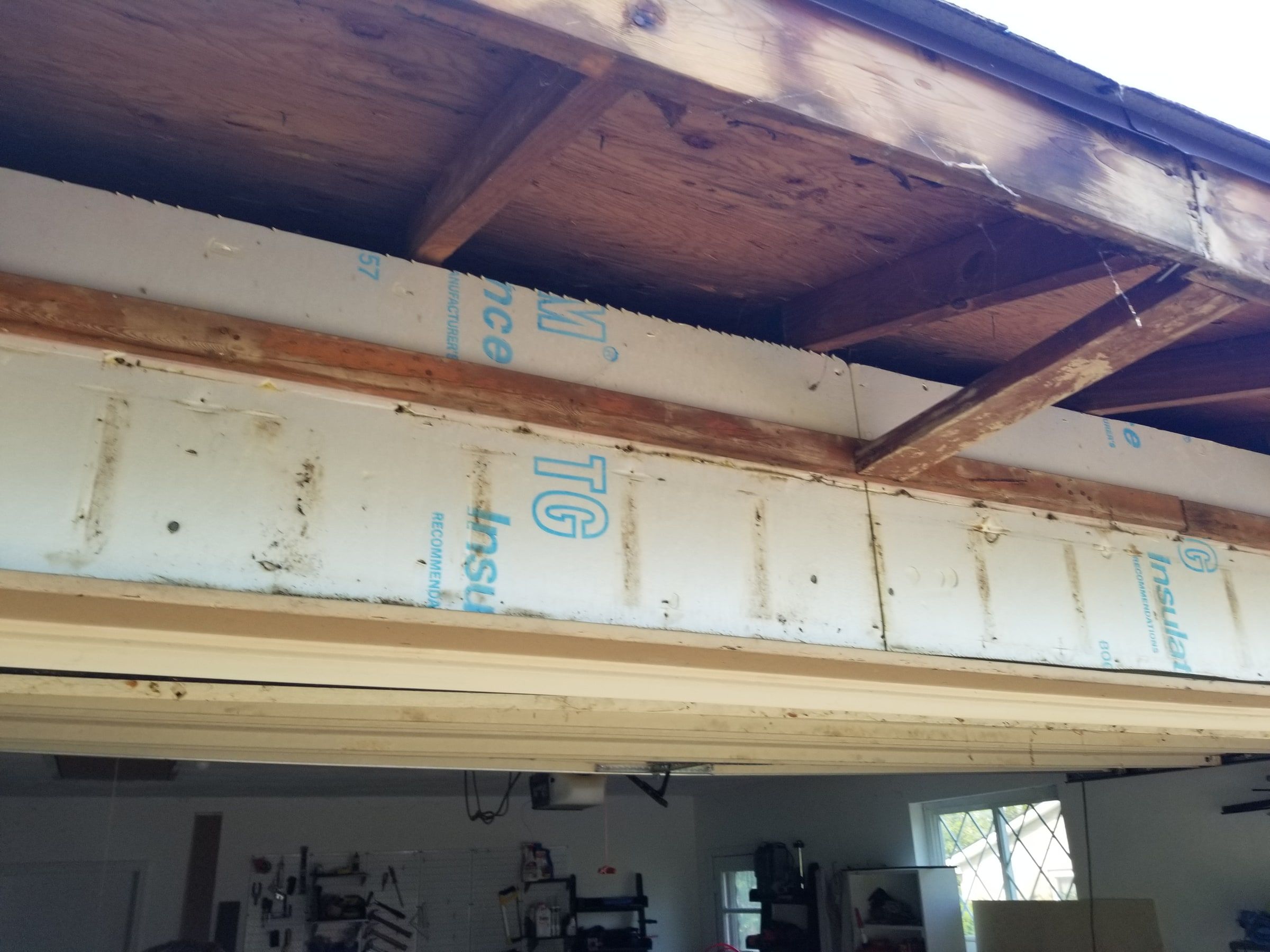 The open eave above the garage door, showing the wood before the new soffit, Beavercreek, Ohio.