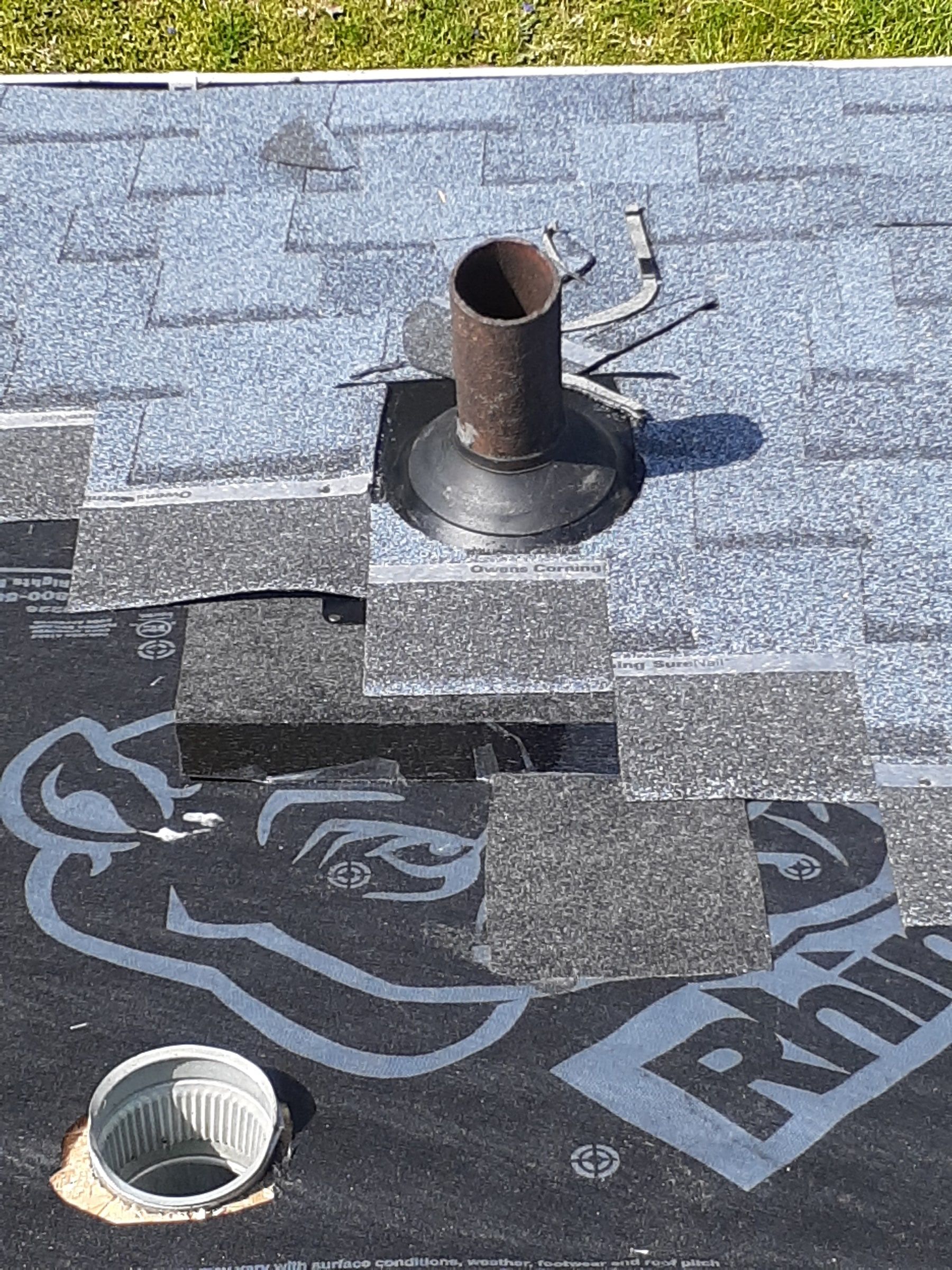 A new pipe boot set over a vent stack as the shingles go on around it, Yellow Springs, Ohio.