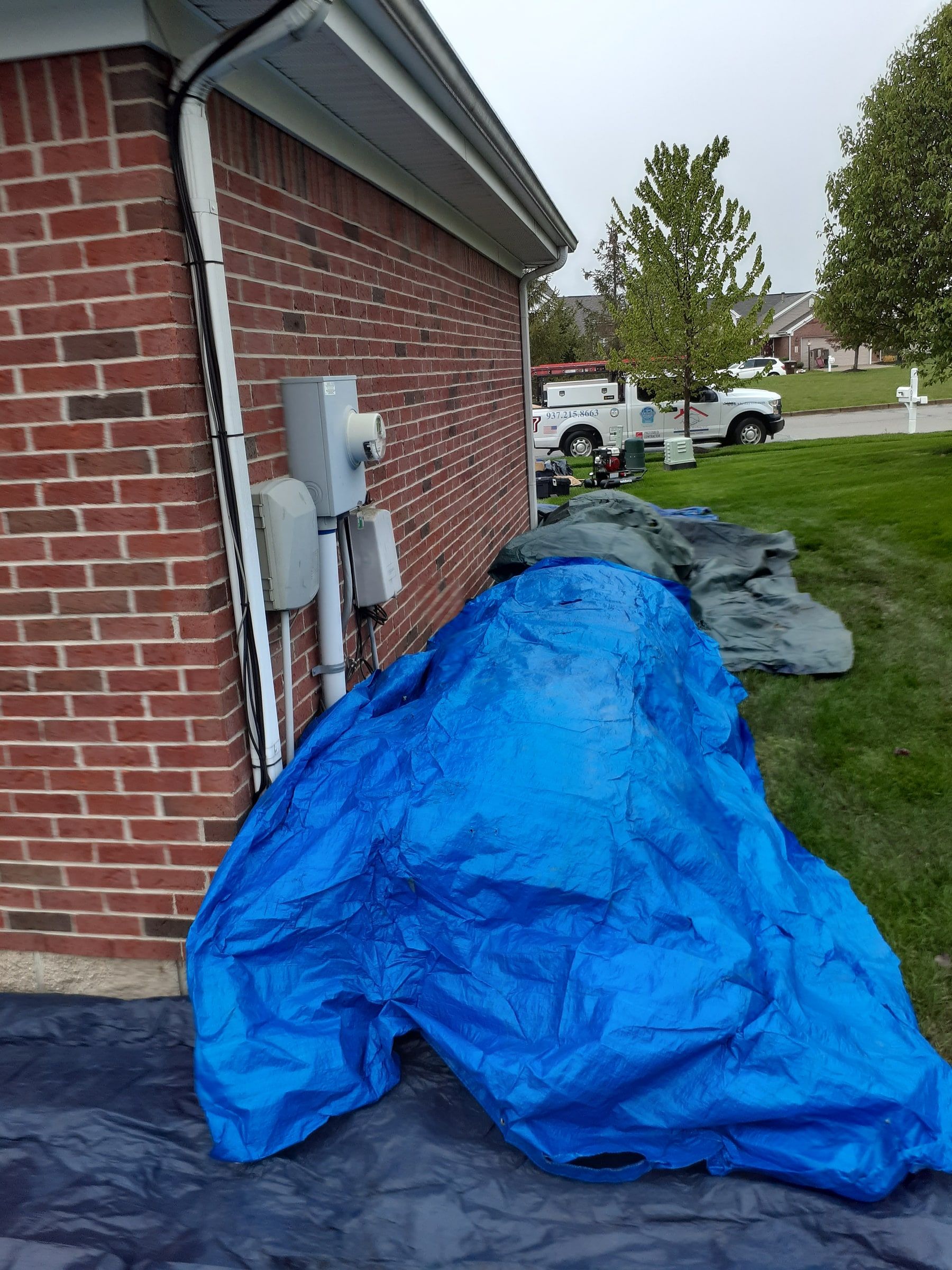 Ground tarps along the side past the meters