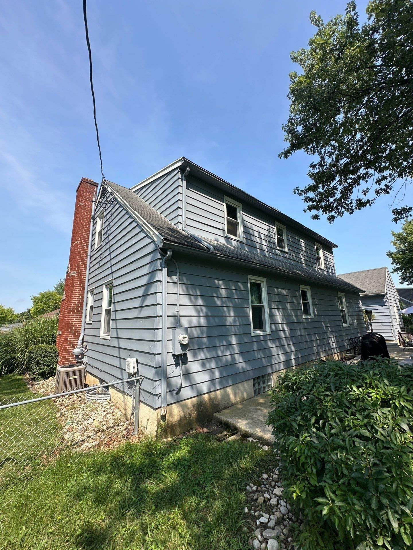 The long side of the house with its dormer, along the fence, Beavercreek, Ohio.