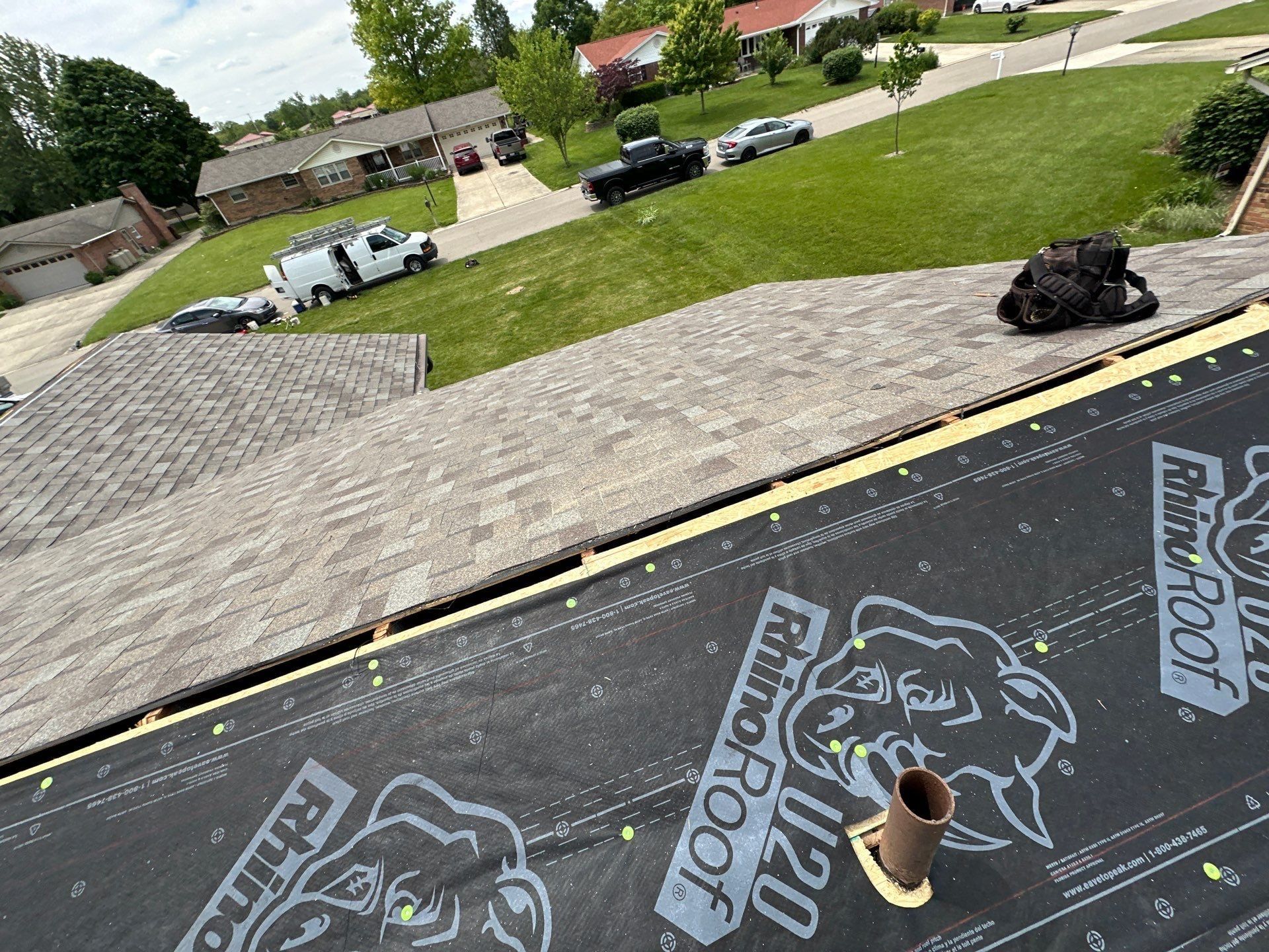 New underlayment on the back slope meeting the finished front roof, Beavercreek, Ohio.