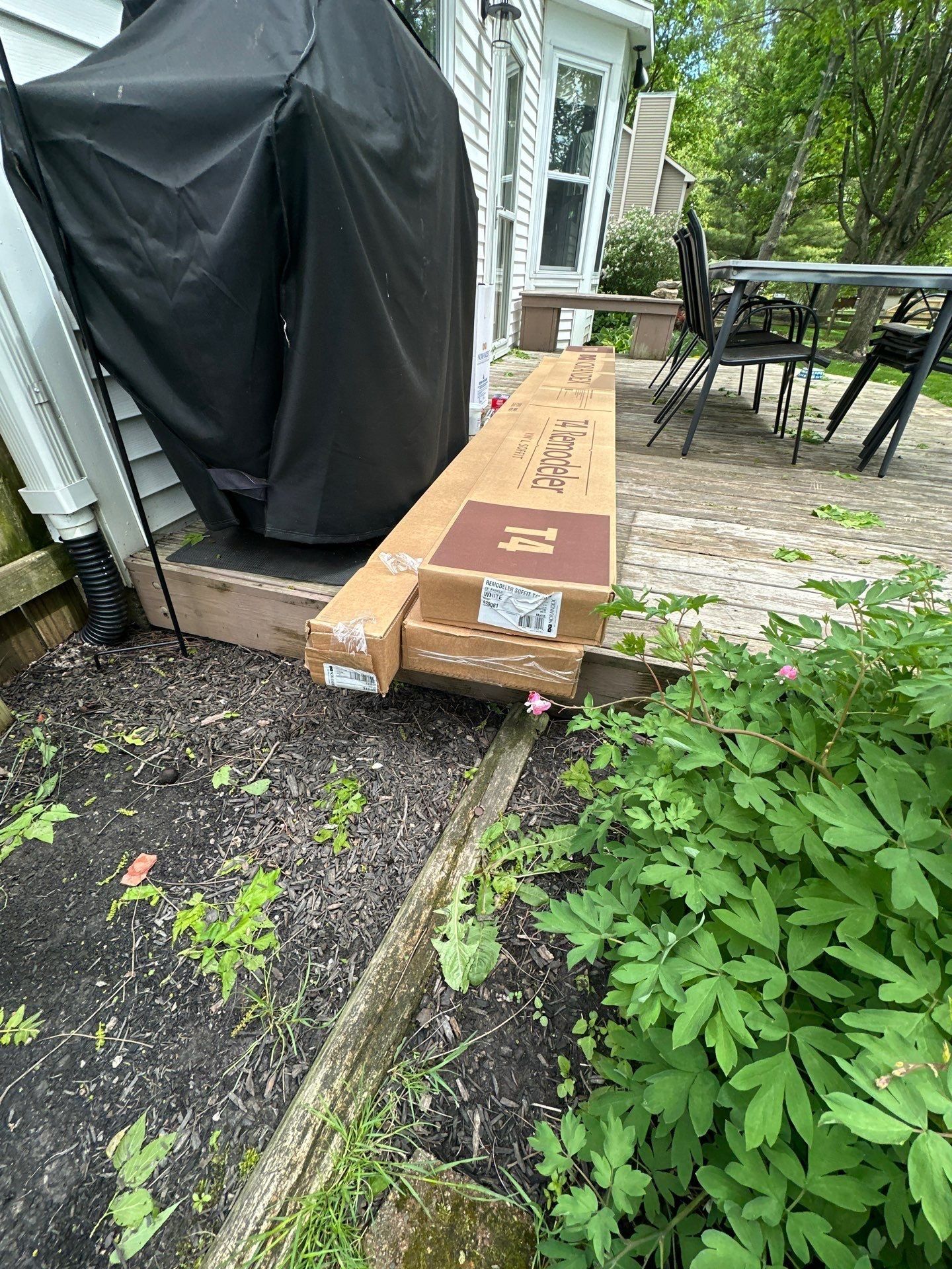 Covered grill, stacked chairs and soffit cartons