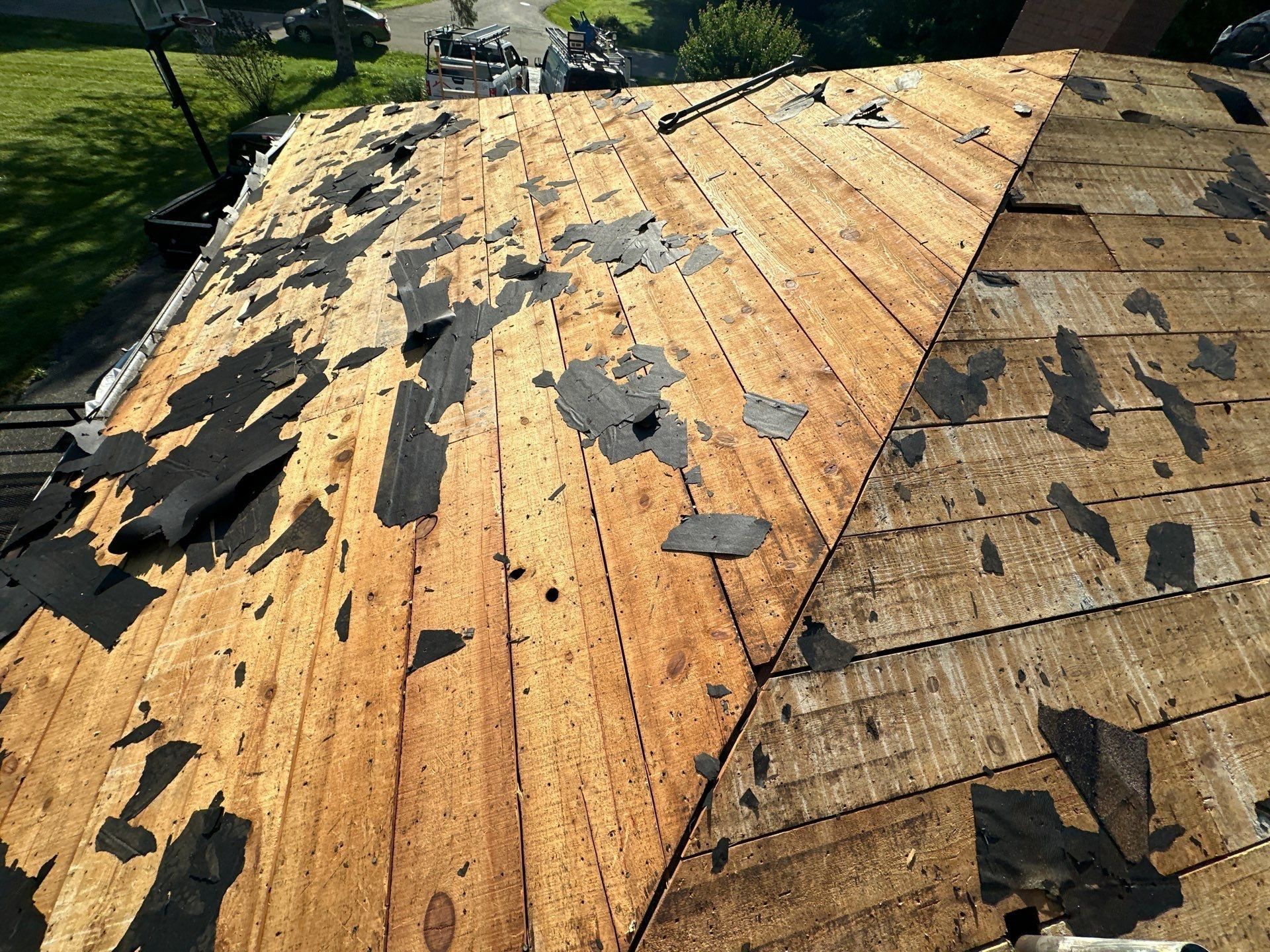 Torn off hip section showing bare plank deck on two roof planes, Beavercreek, Ohio.