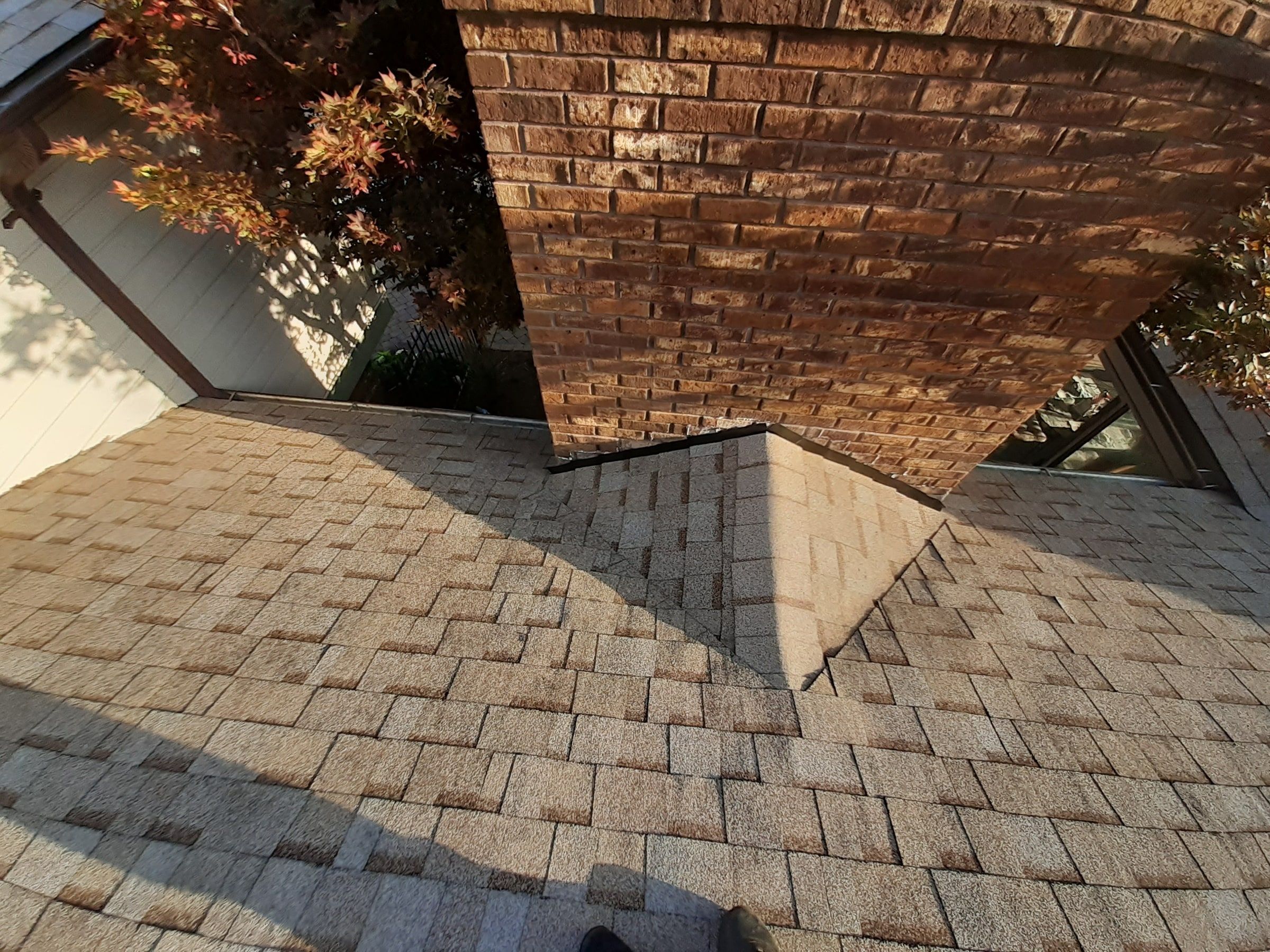 Chimney base with shingles cut in before the metal flashing goes on, Jamestown, Ohio.
