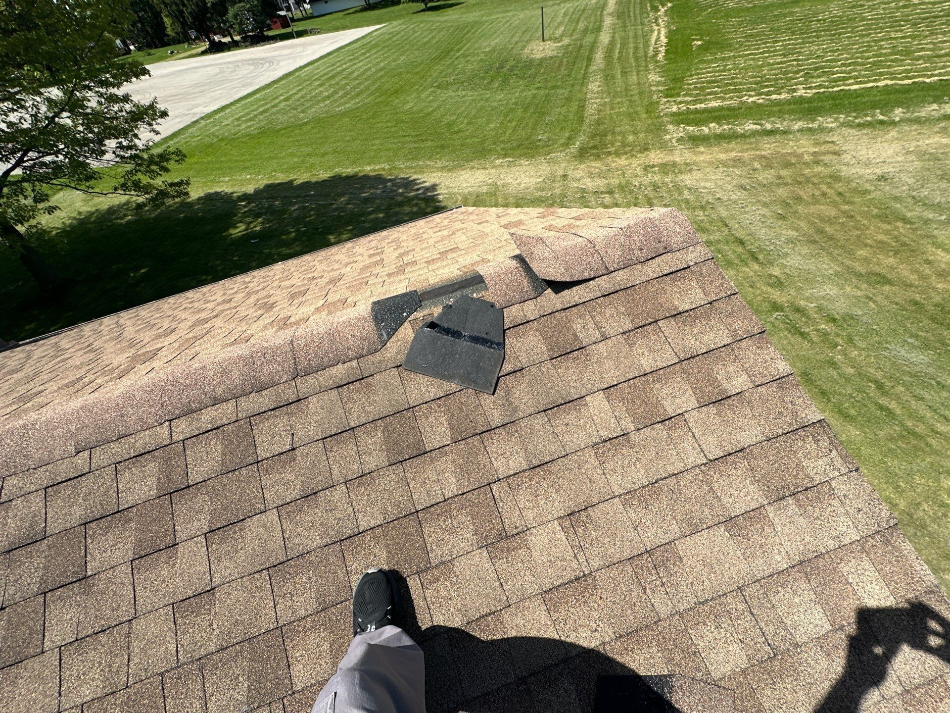 A torn piece of ridge cap lying near the roof edge, Xenia, Ohio.