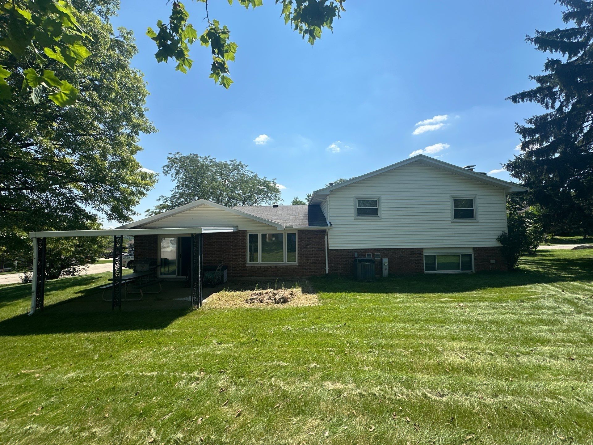 The back of the house from the yard, with the covered patio and the old roof, West Carrollton, Ohio.