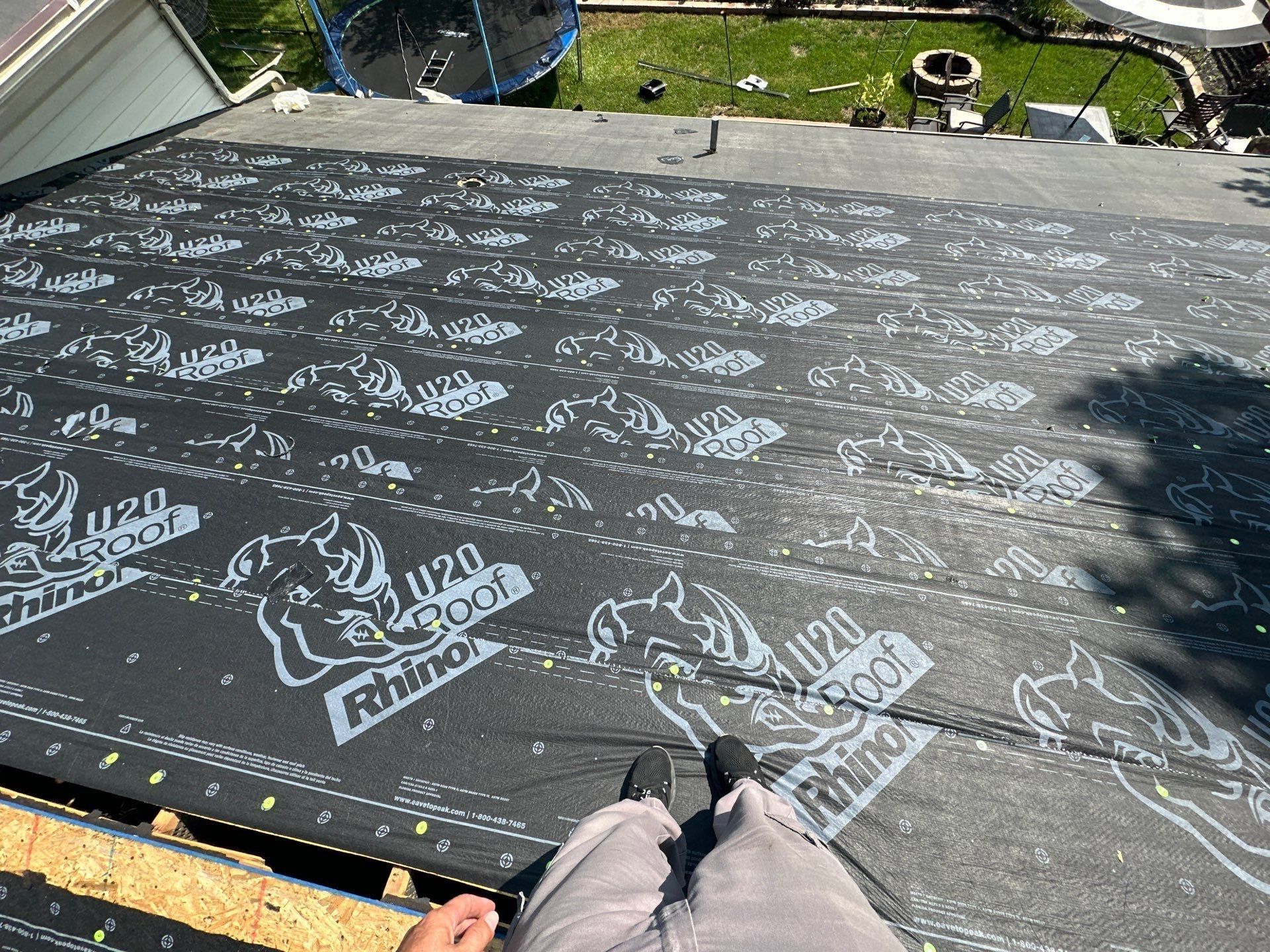 Rows of RhinoRoof synthetic underlayment over the back slope, above the yard, Dayton, Ohio.