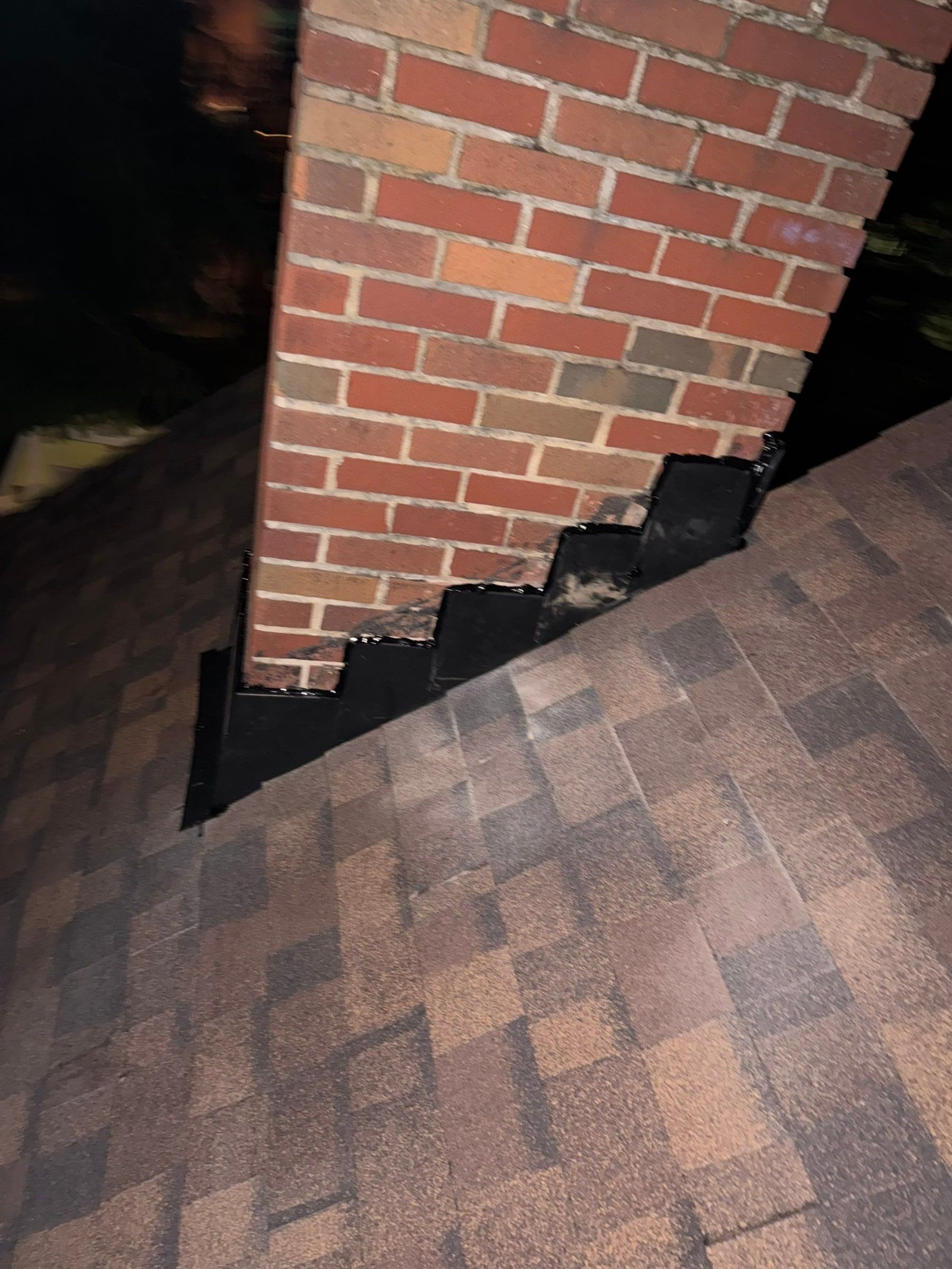 Step flashing in the chimney brick courses