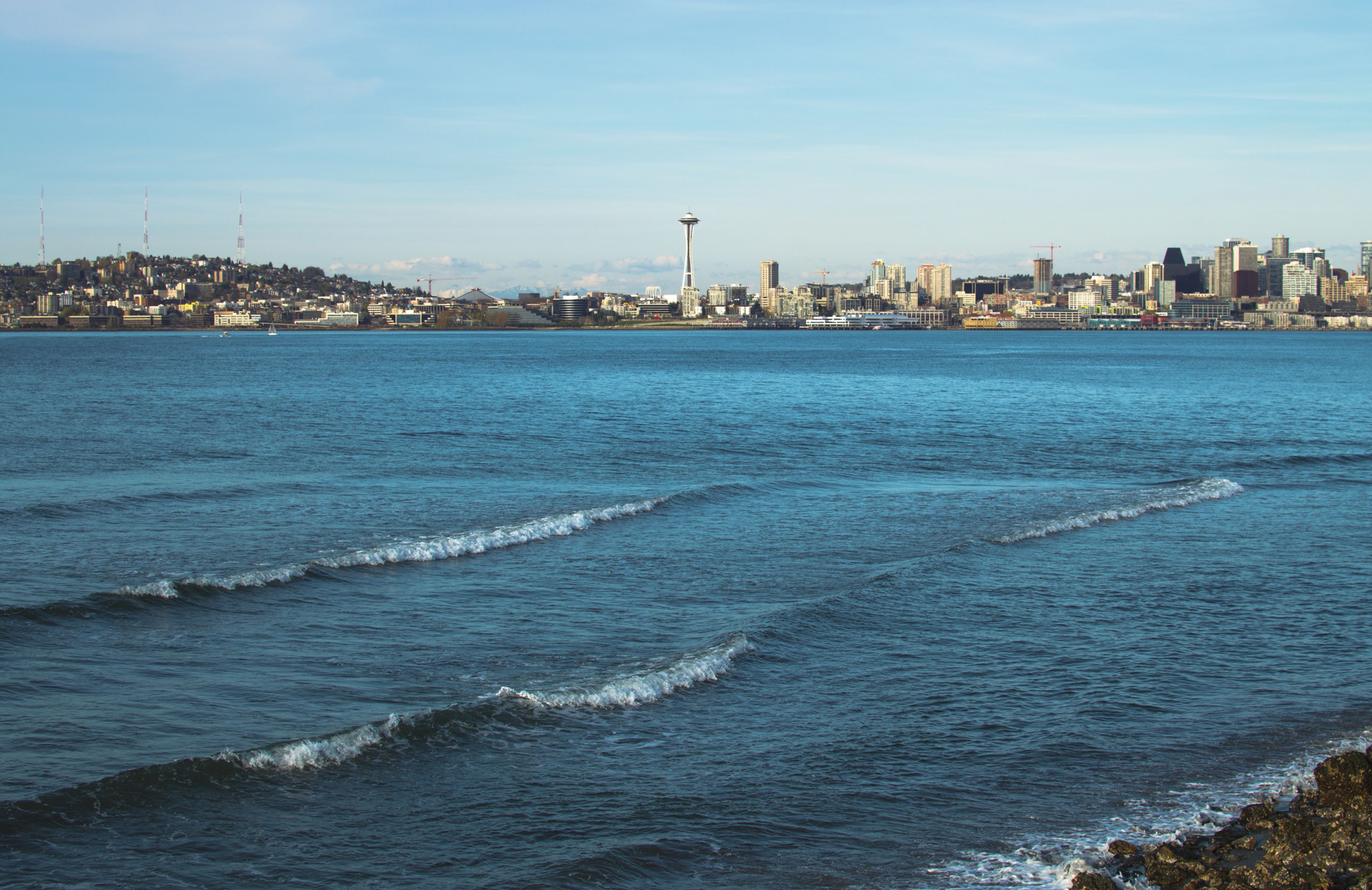 Waves break on the shore at Alki Beach in West Seattle, Washington 