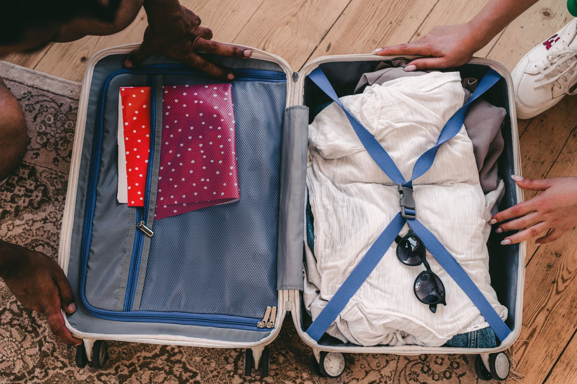 An open suitcase neatly packed with clothes and travel essentials, ready for a trip to Japan