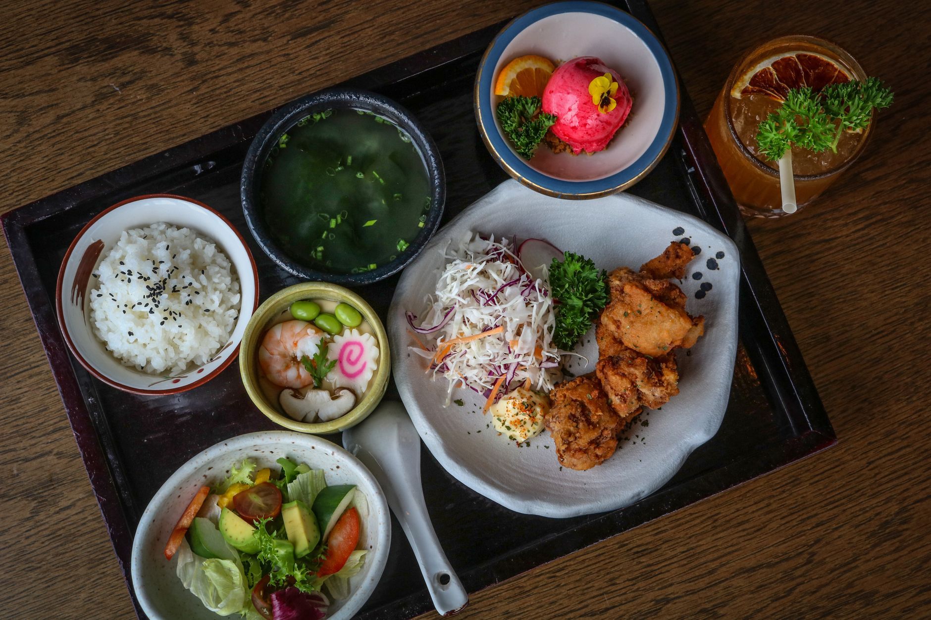 A Japanese meal of tempura, sashimi and rice on a table, the kind of spread allergy travelers must decode for hidden dashi, wheat and soy