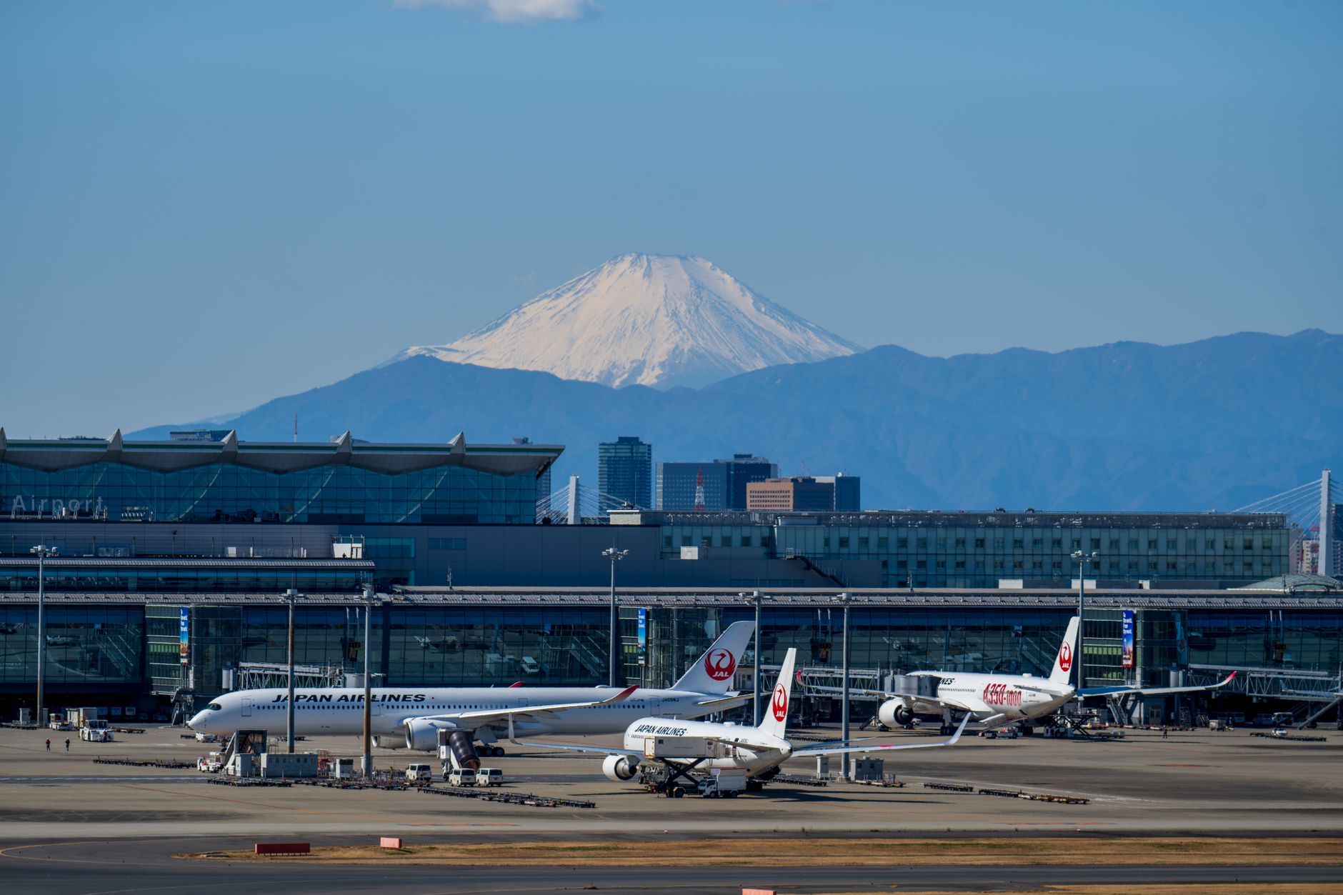 Aircraft on the apron at Tokyo Haneda Airport with Mount Fuji on the horizon