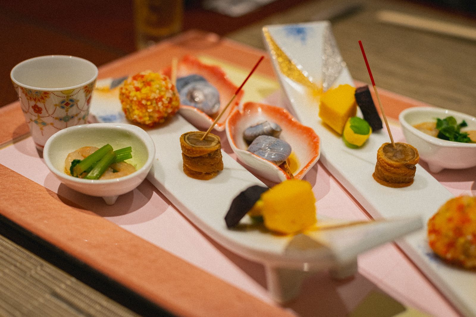 Traditional Japanese kaiseki dishes beautifully arranged in small bowls on a wooden table