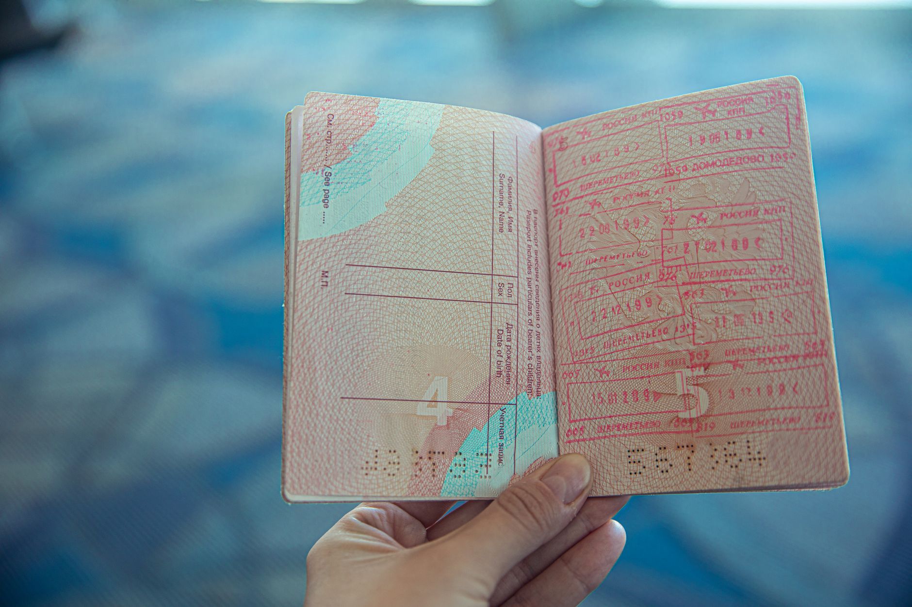 Open passport with immigration entry stamps on an airport counter, illustrating Japan entry requirements