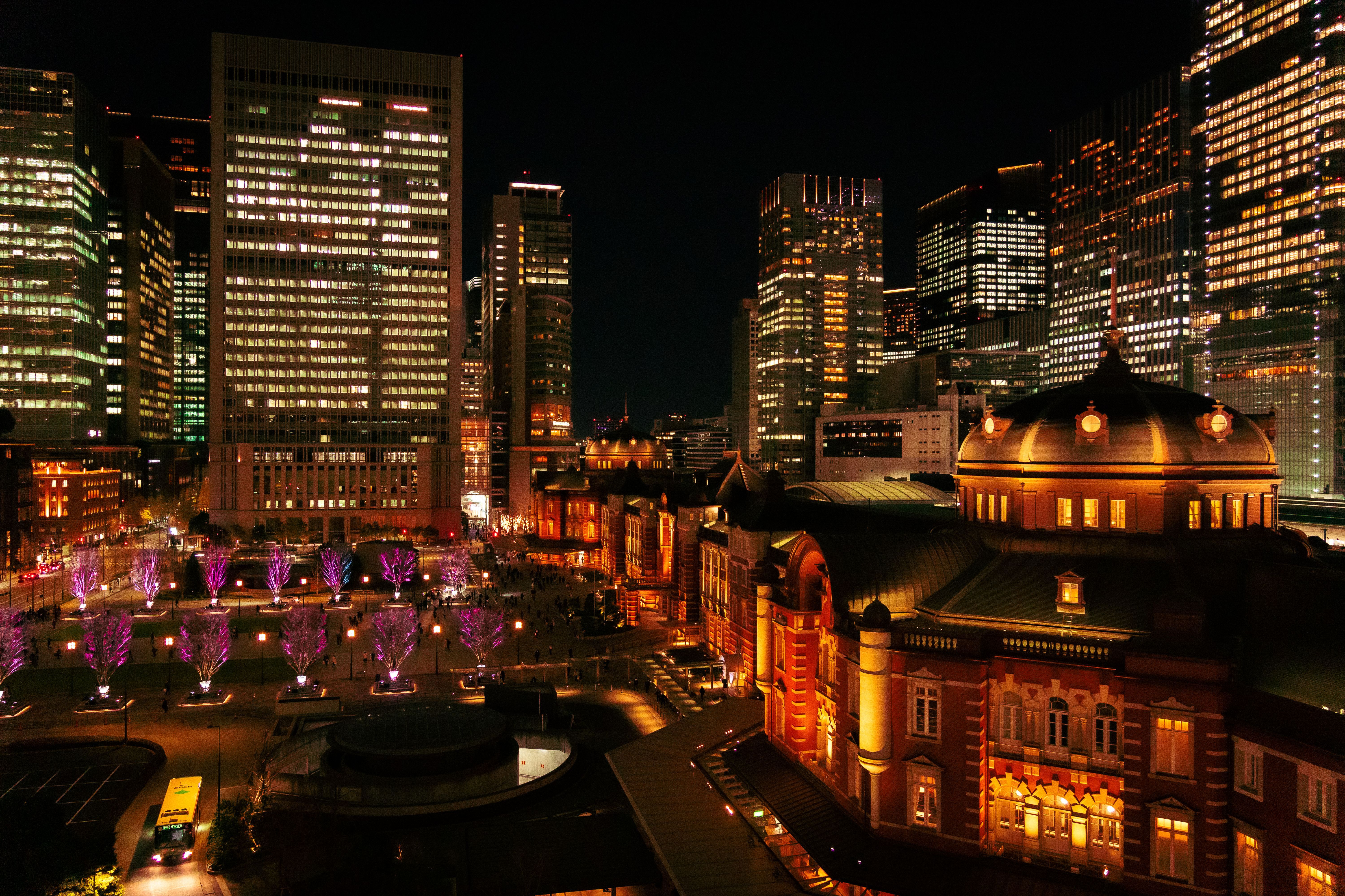 Tokyo Station illuminated at night with surrounding skyscrapers during the December winter lights season