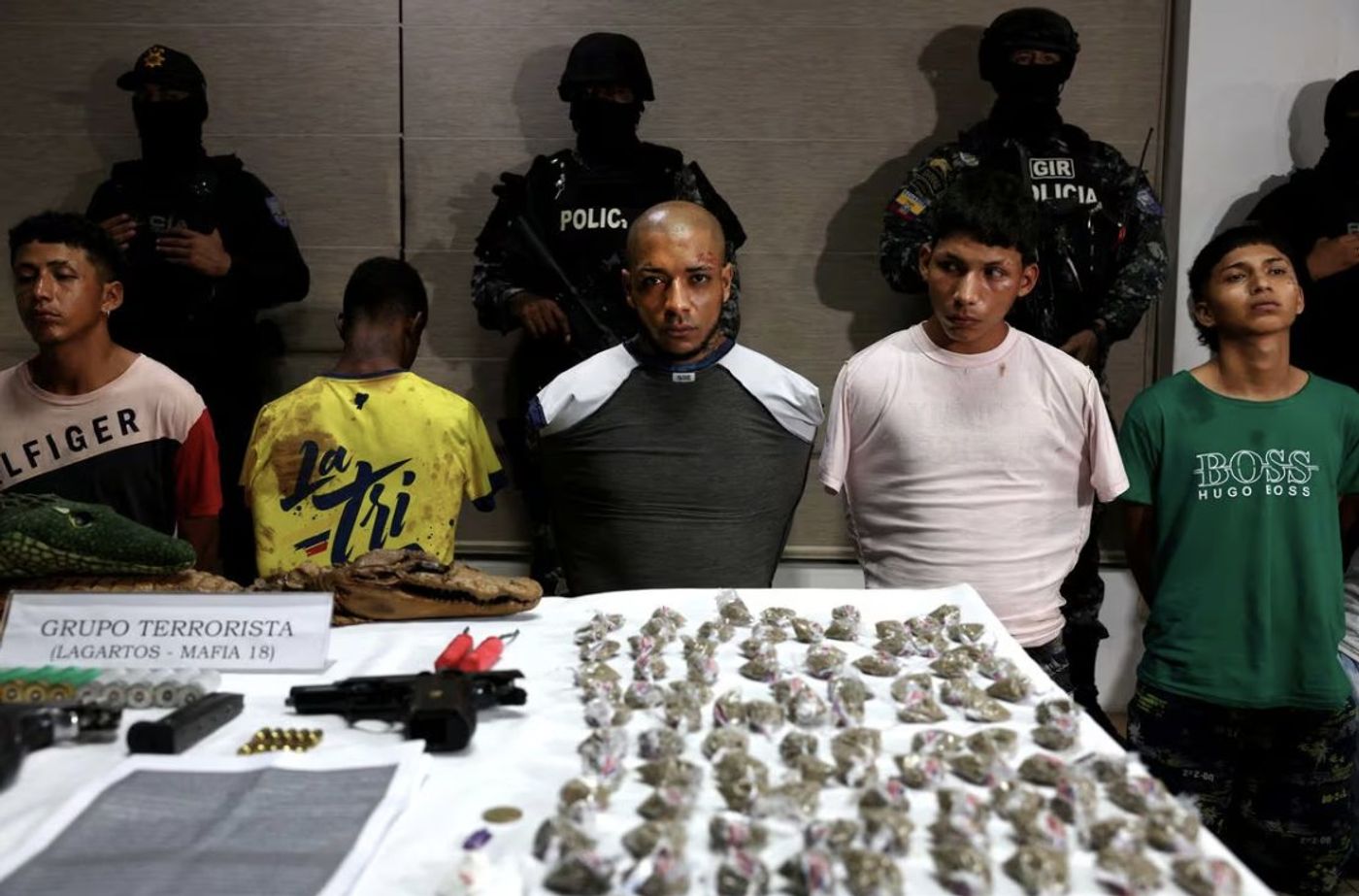Alleged Los Lagartos members at a police station in Guayaquil