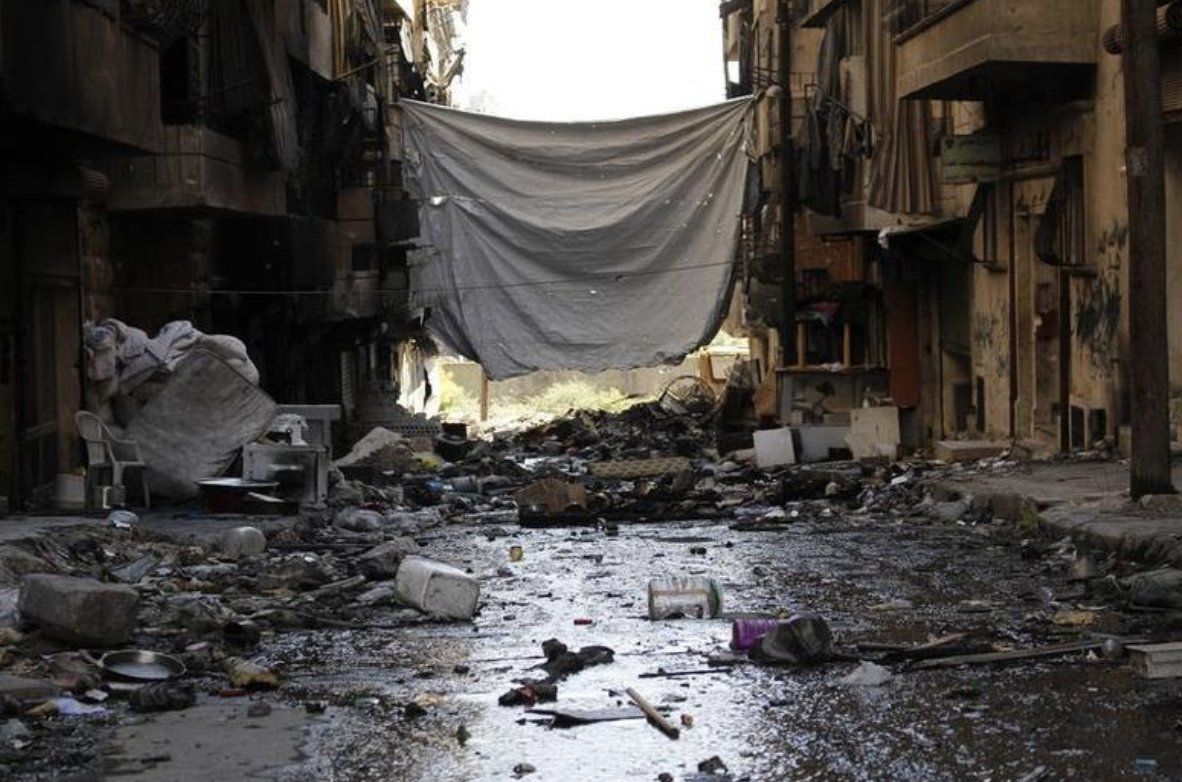A sheet strung across a street to block snipers' line of sight — Sheikh Maksoud, Aleppo, 2013