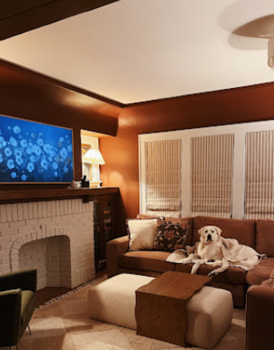 Cozy living room with warm terracotta walls, white brick fireplace, and natural light