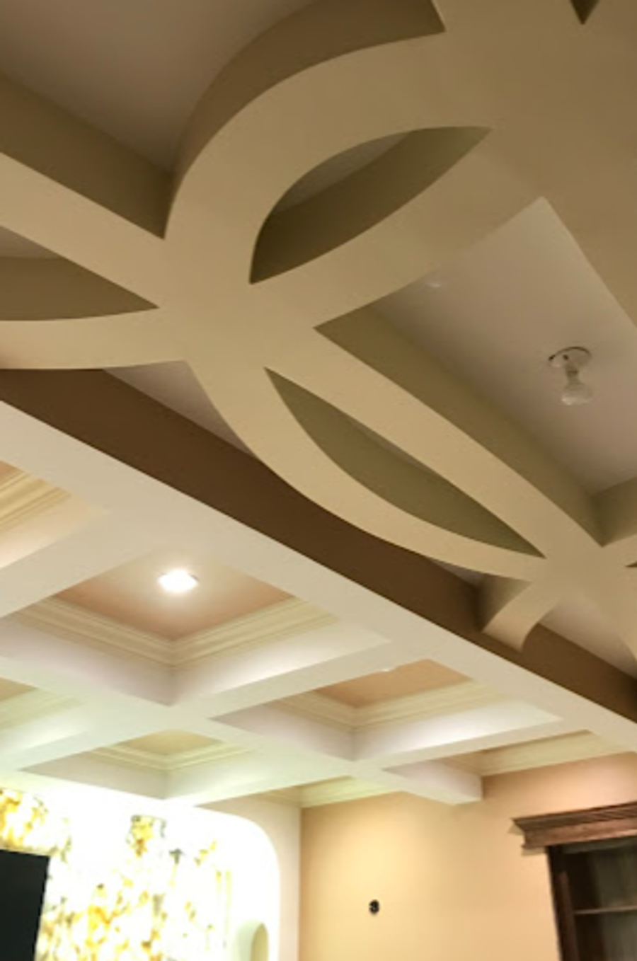 Custom decorative coffered ceiling with painted circular cut-out design in cream and taupe