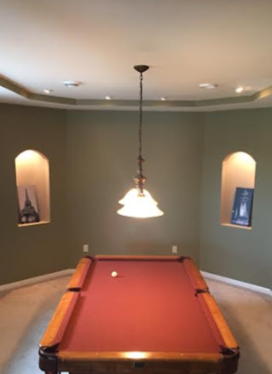 Game room with sage green walls, tray ceiling, and refinished pool table