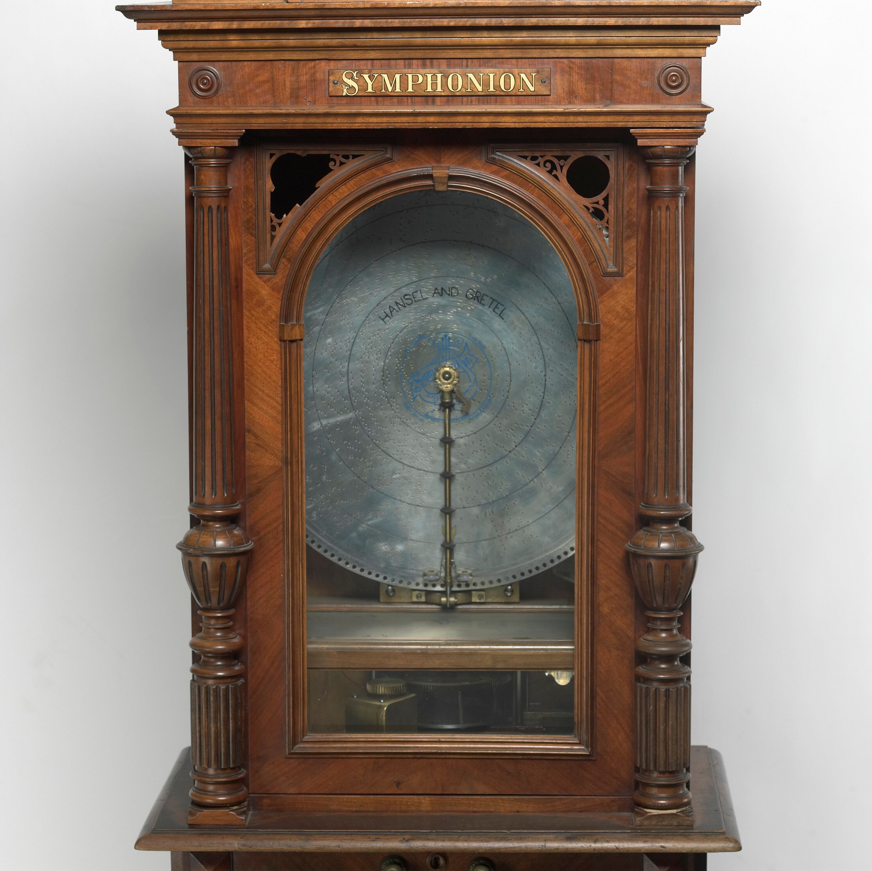 Symphonion nameplate above the steel disc in its wooden cabinet