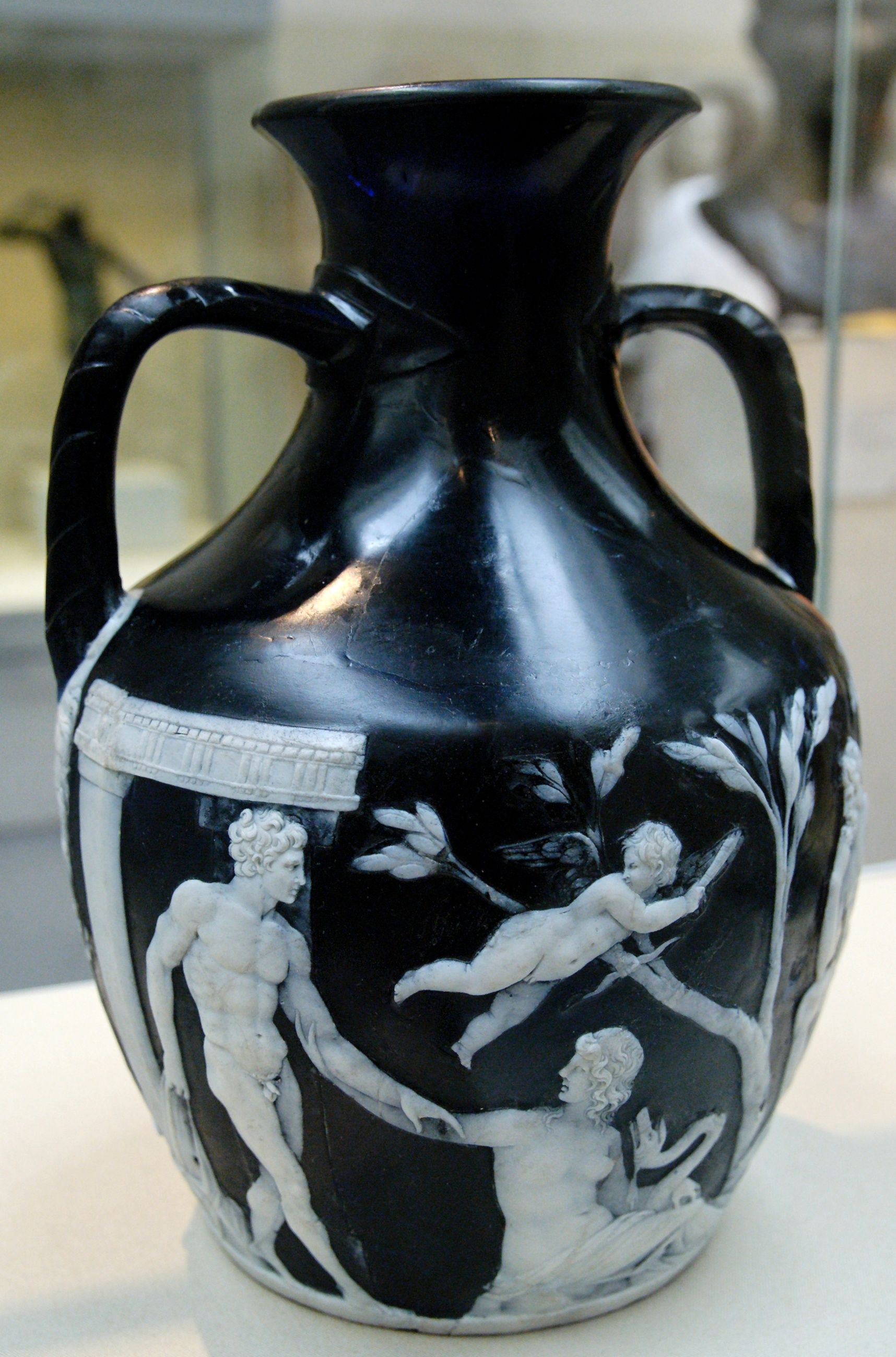 The Roman Portland Vase, with white figures carved from a layer over deep blue glass
