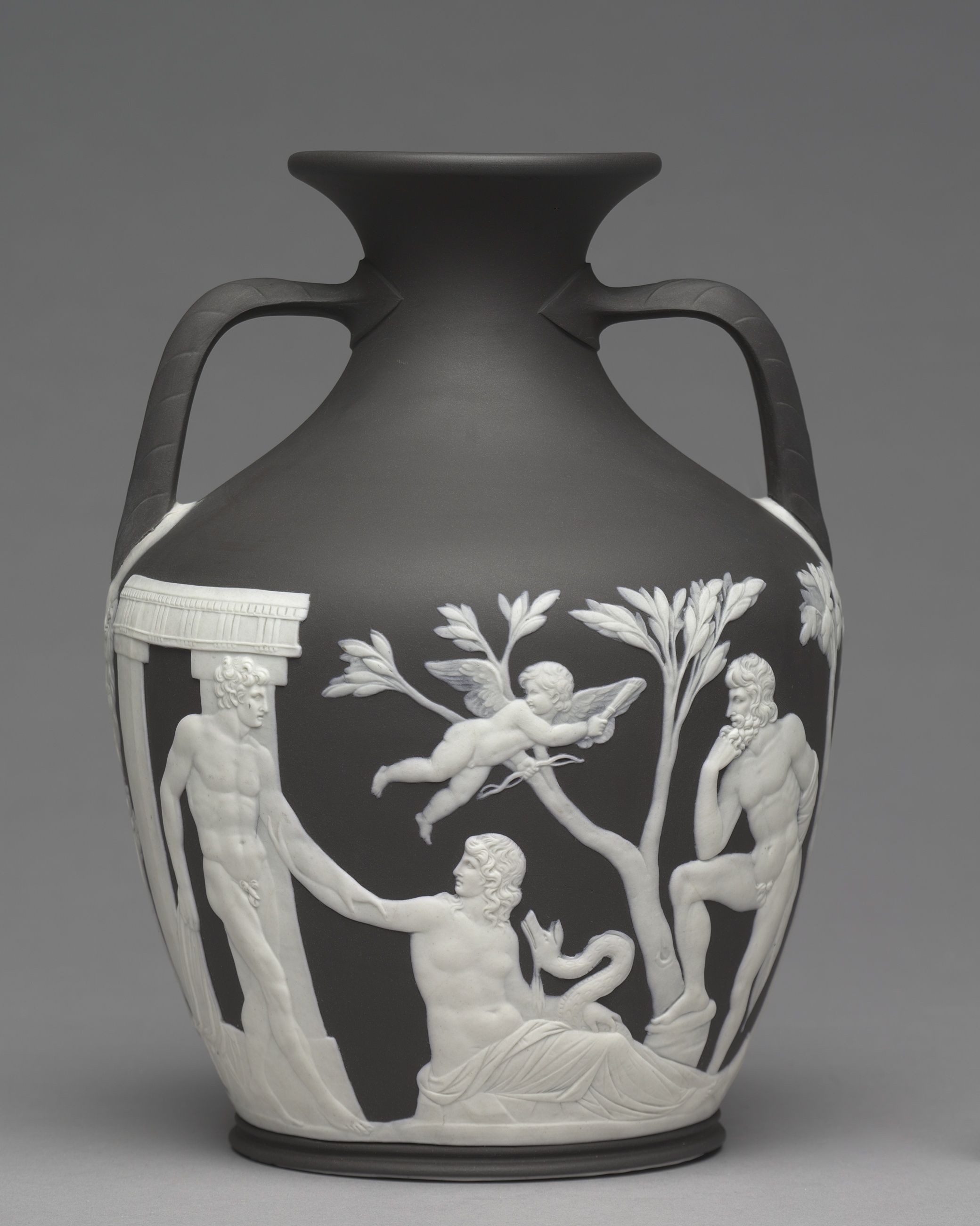An early Wedgwood Portland Vase with dark body, angular handles and applied white classical figures