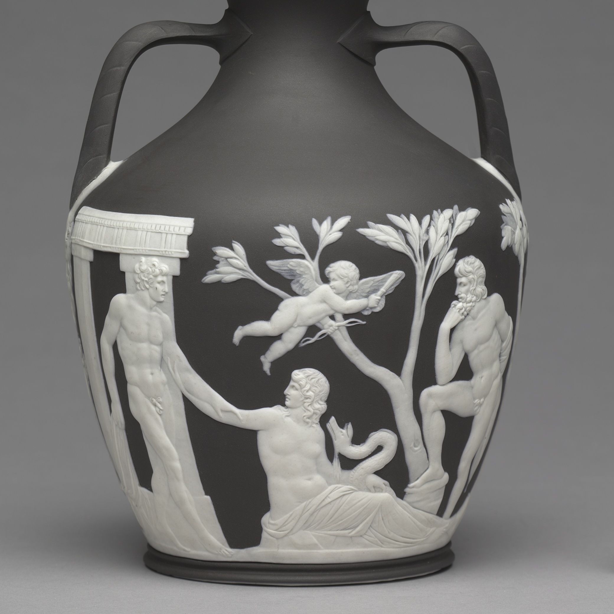 White classical figures and a winged child on the dark body of an early Wedgwood Portland Vase