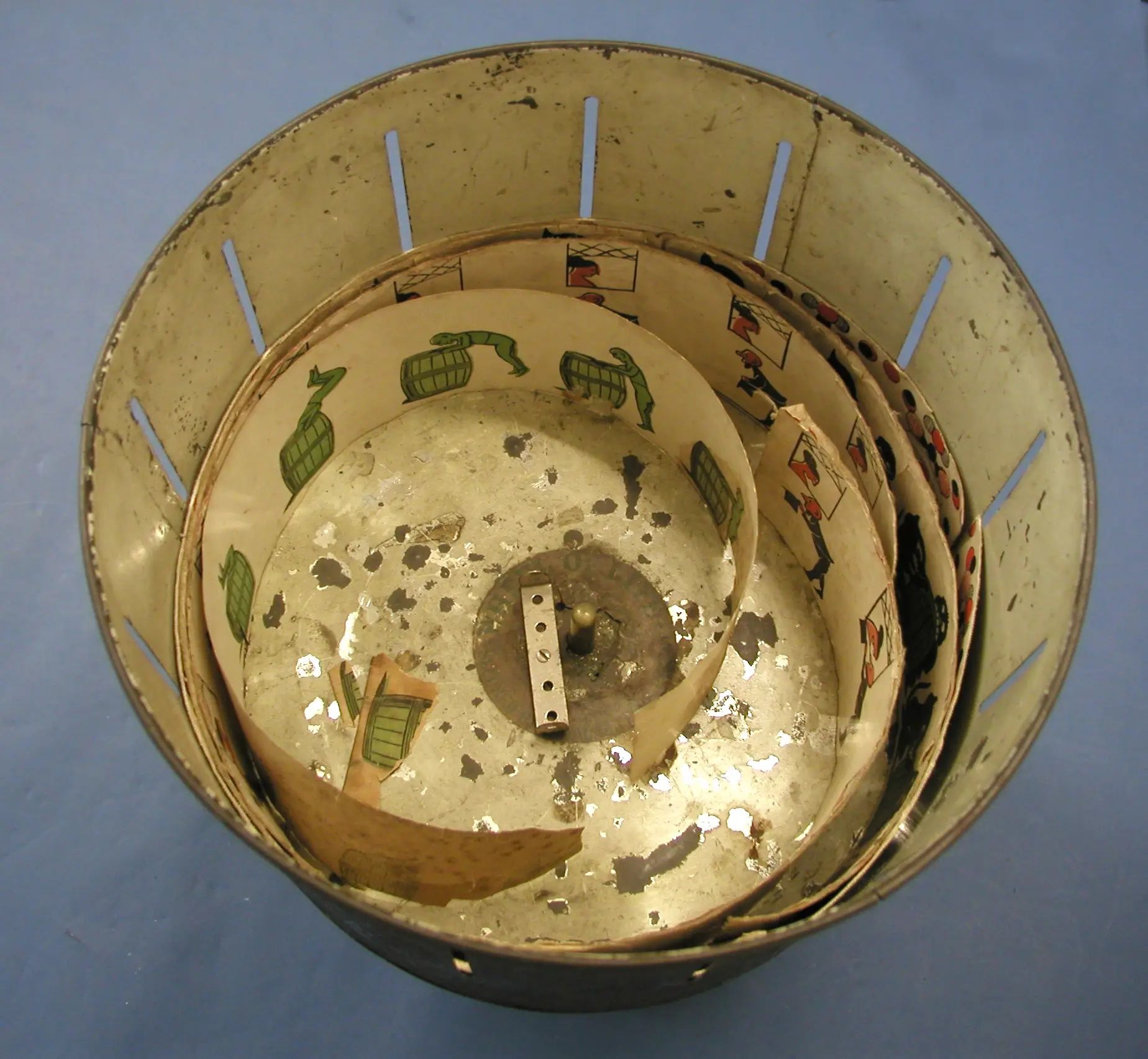 A view down into the slotted drum, with several picture strips loosely nested around its central pivot