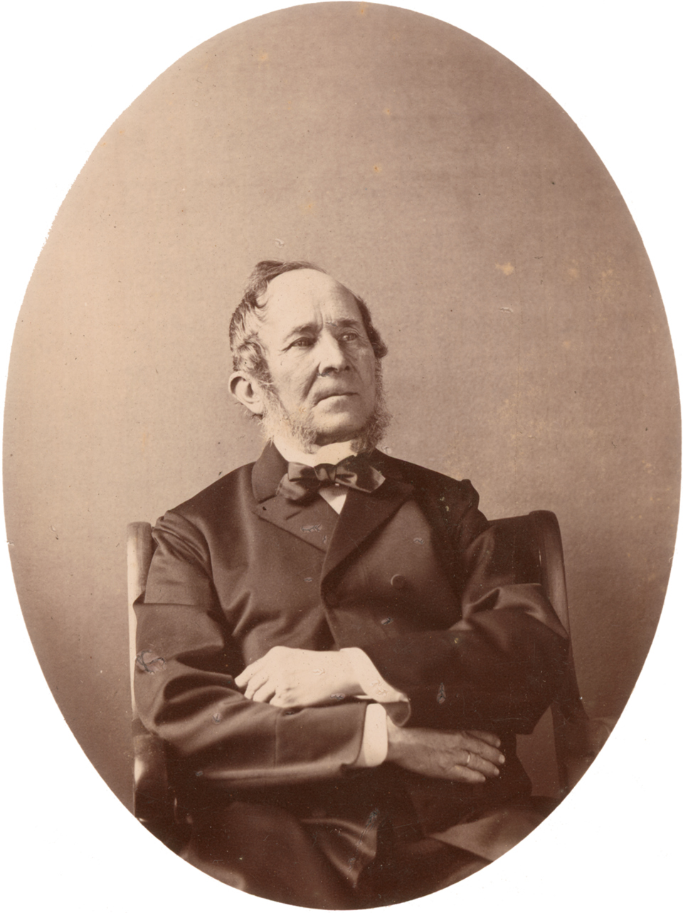 An oval studio portrait of Leopold Blaschka, seated with his arms folded.