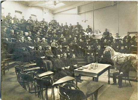 A large group of students in a lecture room, with James Law and an anatomical horse model at the front.