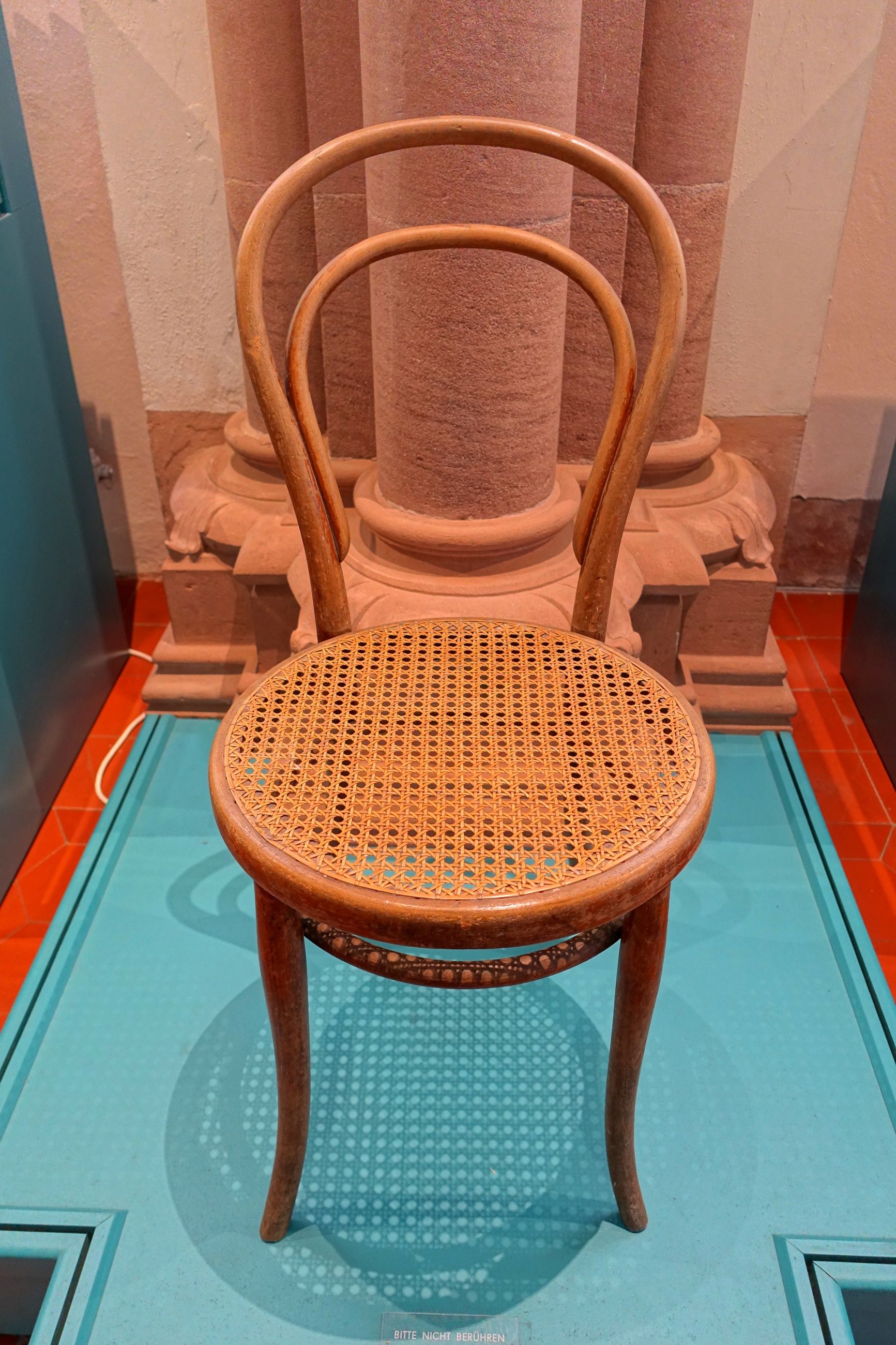 A later No. 14 chair with two curved back bows, a circular cane seat and a ring connecting the legs