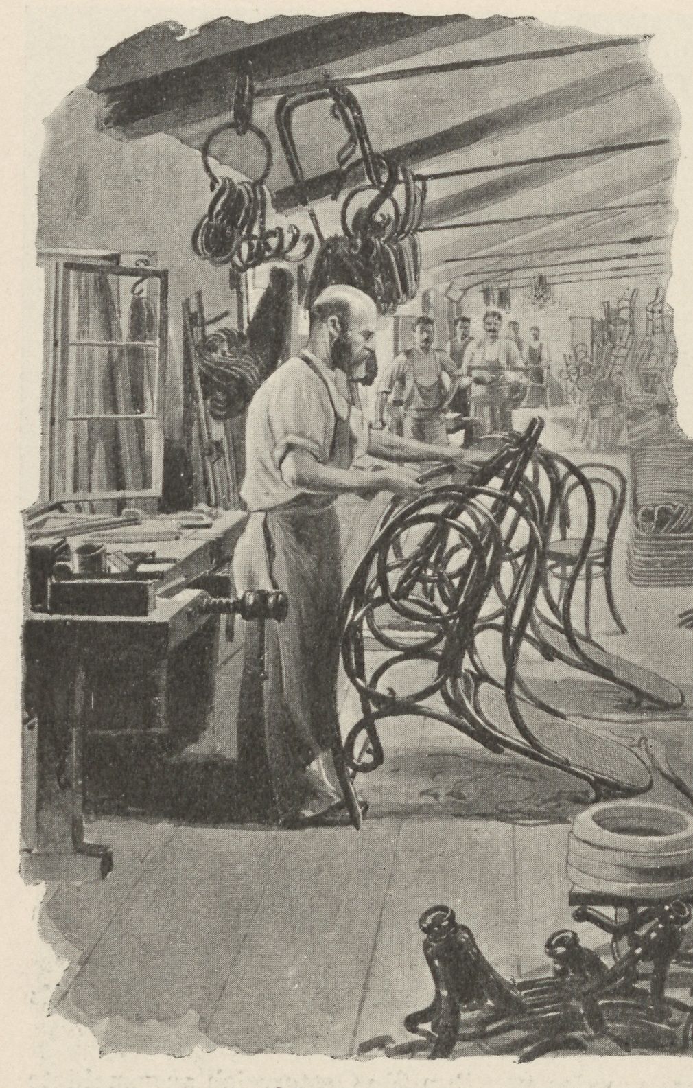 A worker assembling curved chair parts in the Bistritz factory, with further frames overhead and behind him