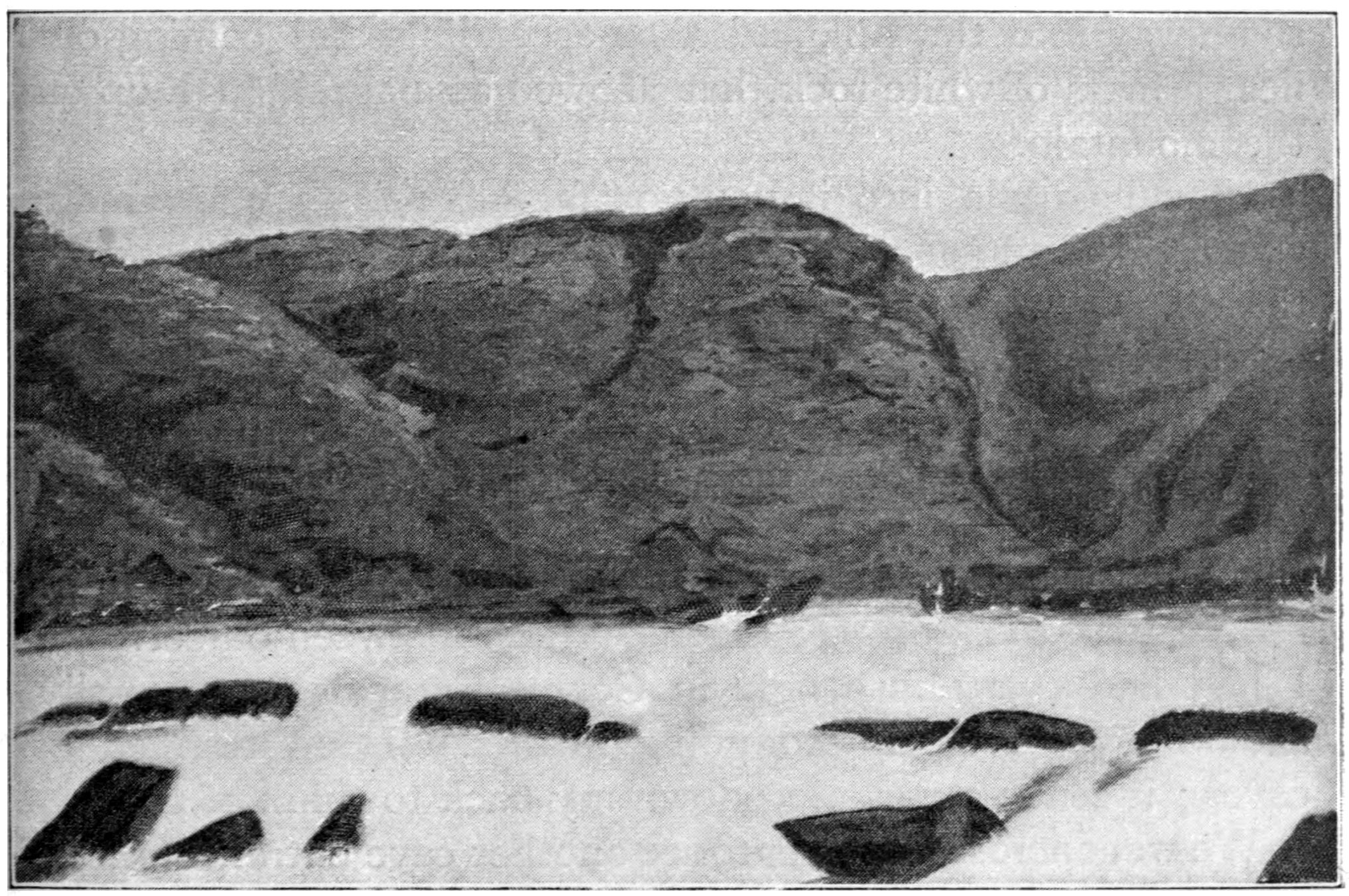 Dark rocks and wooded banks constricting foaming water at the Boko Boko rapids