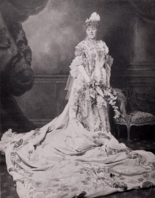 Margaret Brooke standing in an elaborate embroidered dress and long train.