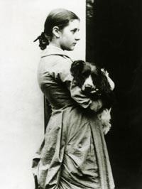 Beatrix Potter aged fifteen holding her dog Spot in a photograph by her father