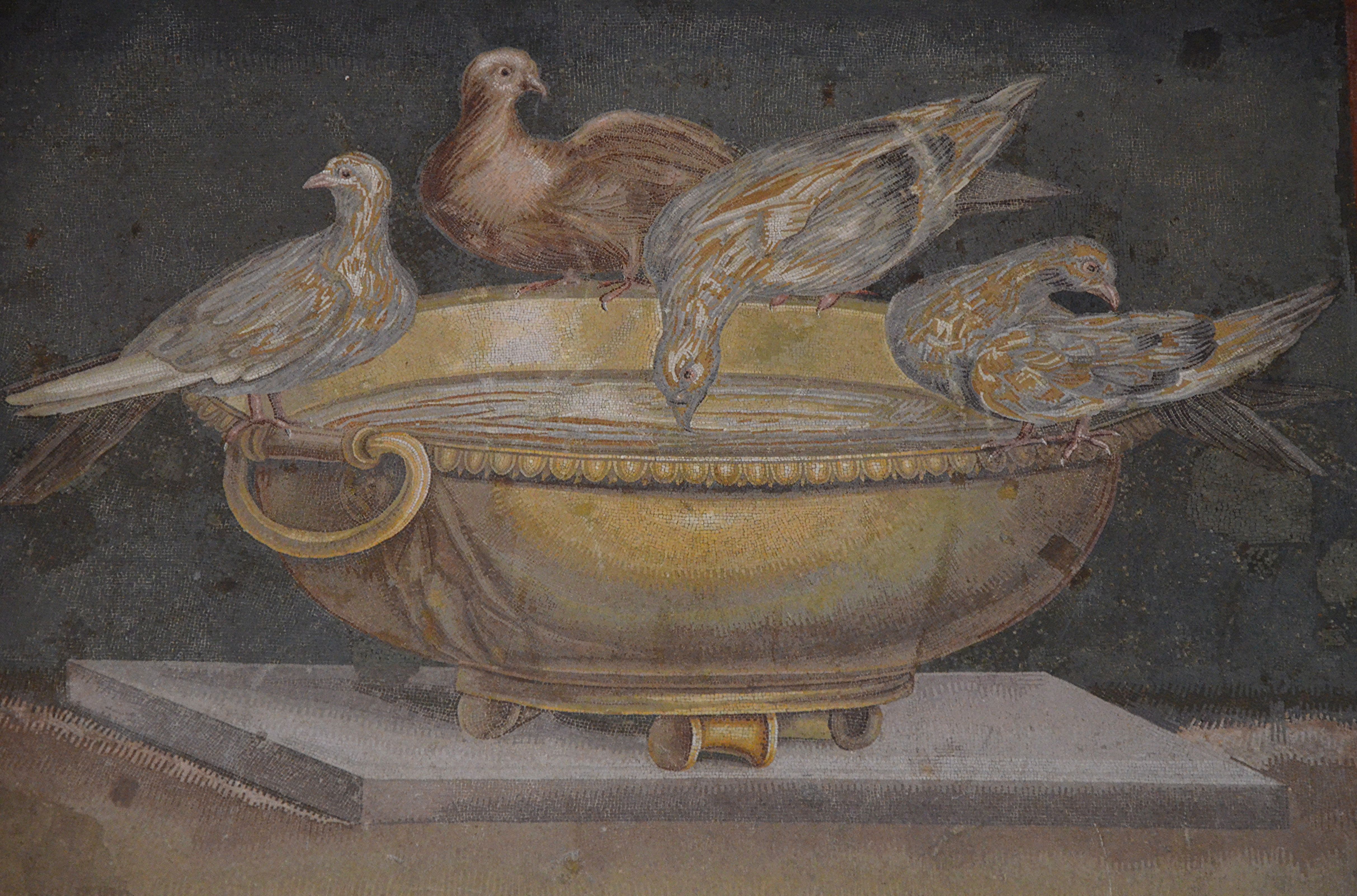 Four ancient mosaic doves around a golden-coloured bowl at the Capitoline Museums