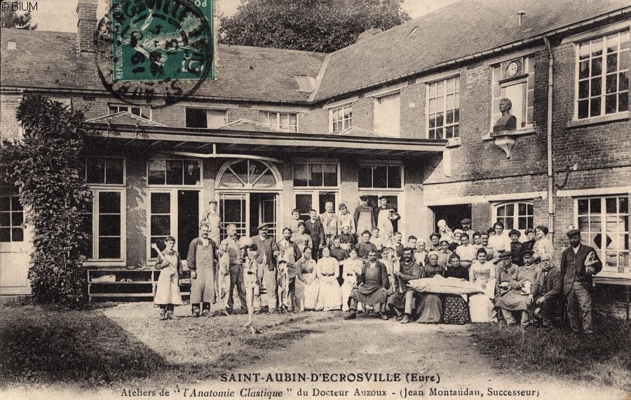 A group of men, women and children gathered outside the Auzoux factory.