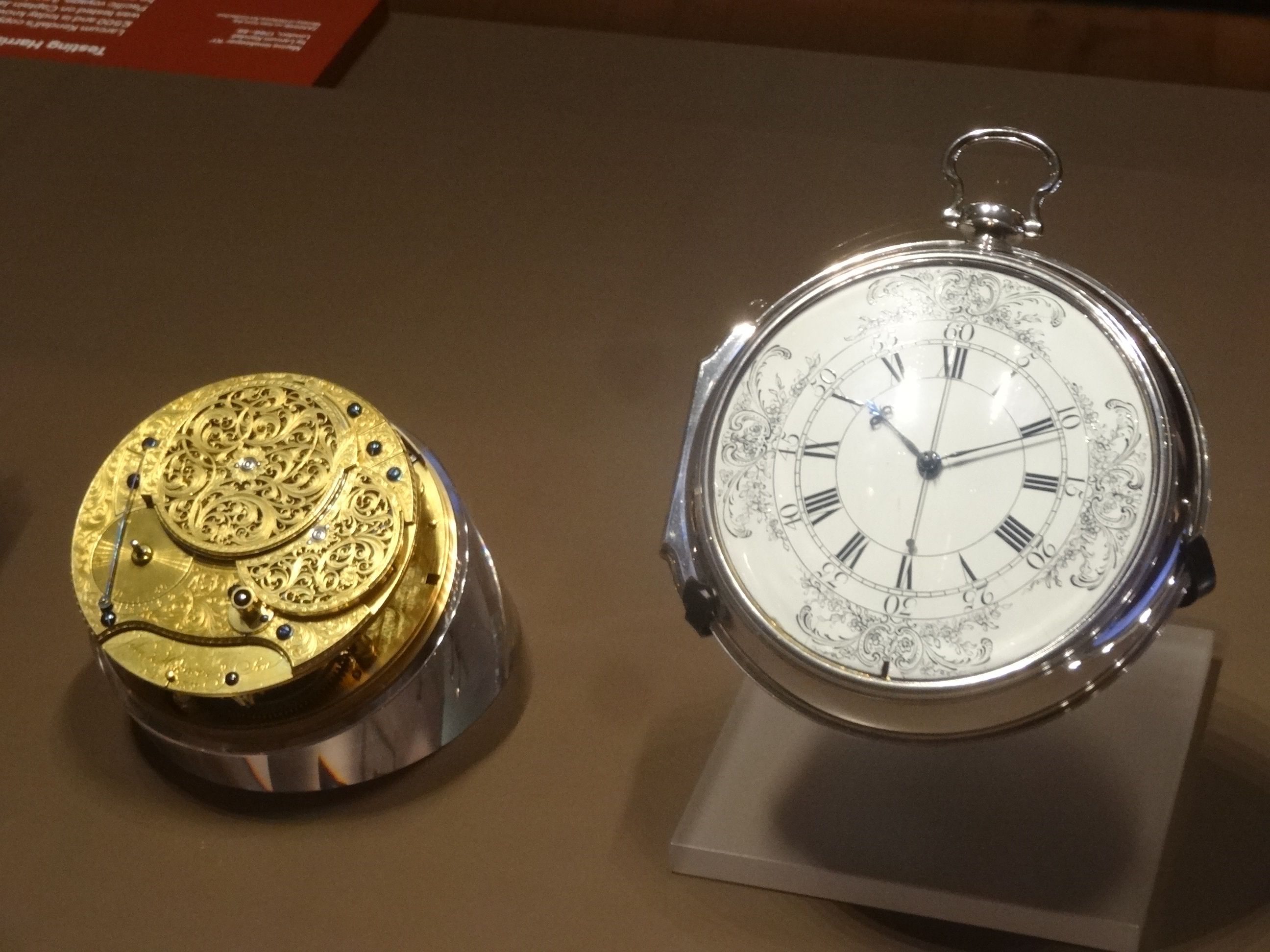 H4's movement and its separate silver case and white dial displayed alongside each other