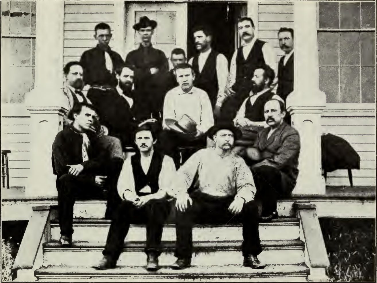 Edison and a group of assistants posed outside a wooden building at Menlo Park