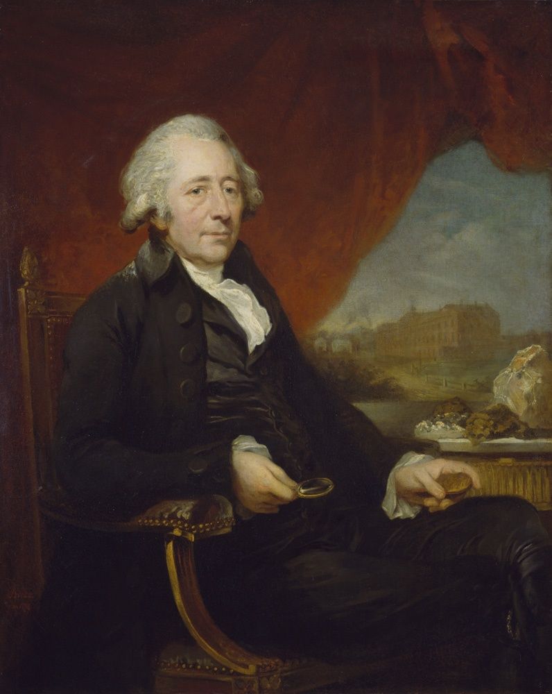 Matthew Boulton seated in a dark coat, holding a small object in each hand