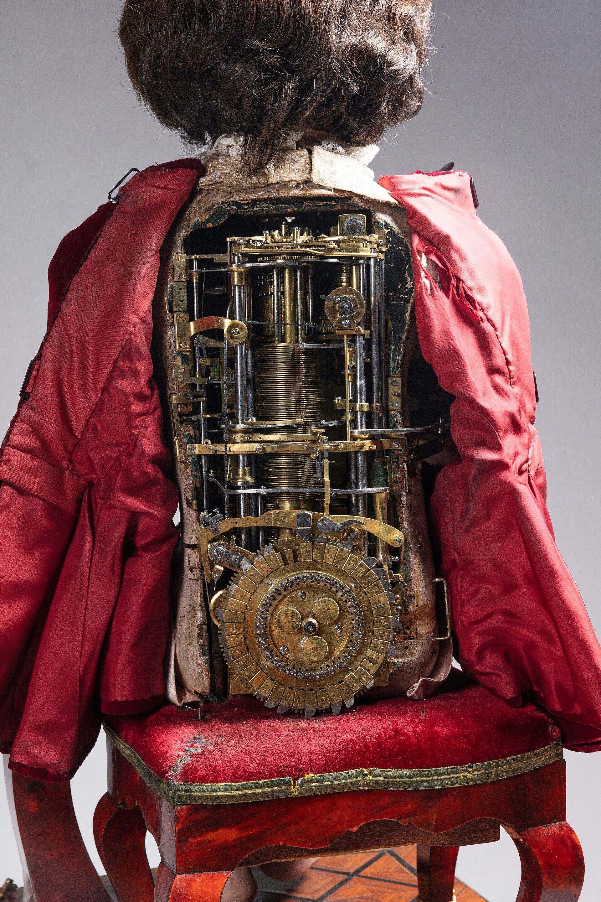 The Writer viewed from behind with its back open, exposing stacked cams, rods and a lower disc.